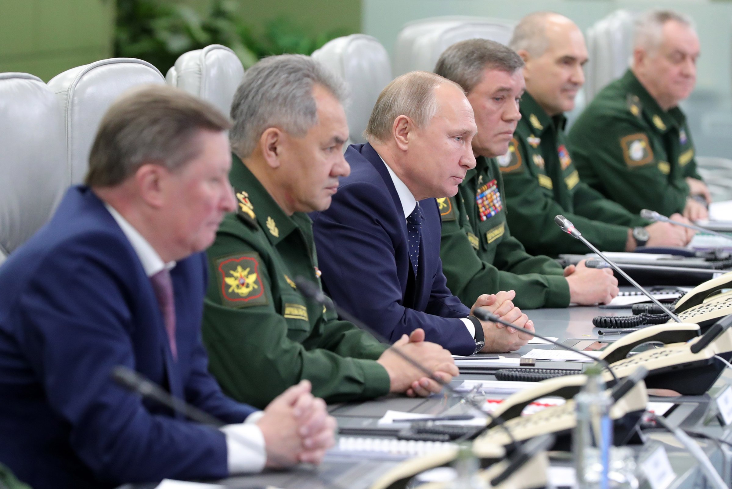 Vladimir Putin, center, watches the launch of a new Russian hypersonic missile system on Dec. 26