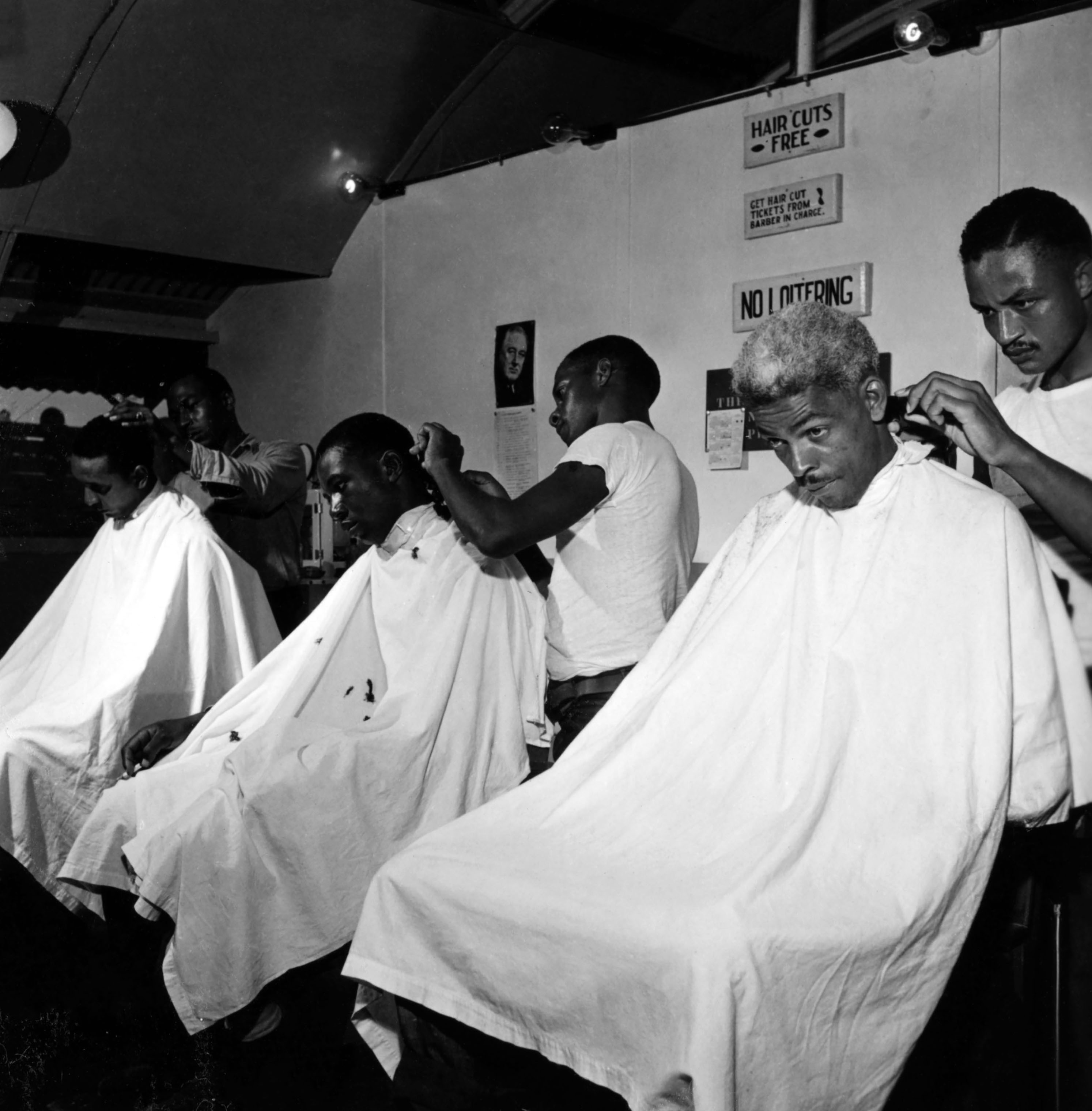 Sailors at the barbershop of the U.S. Naval Supply Depot on Guam, getting their hair cut at the base barbershop, in 1945. (Wayne Miller—Magnum Photos)