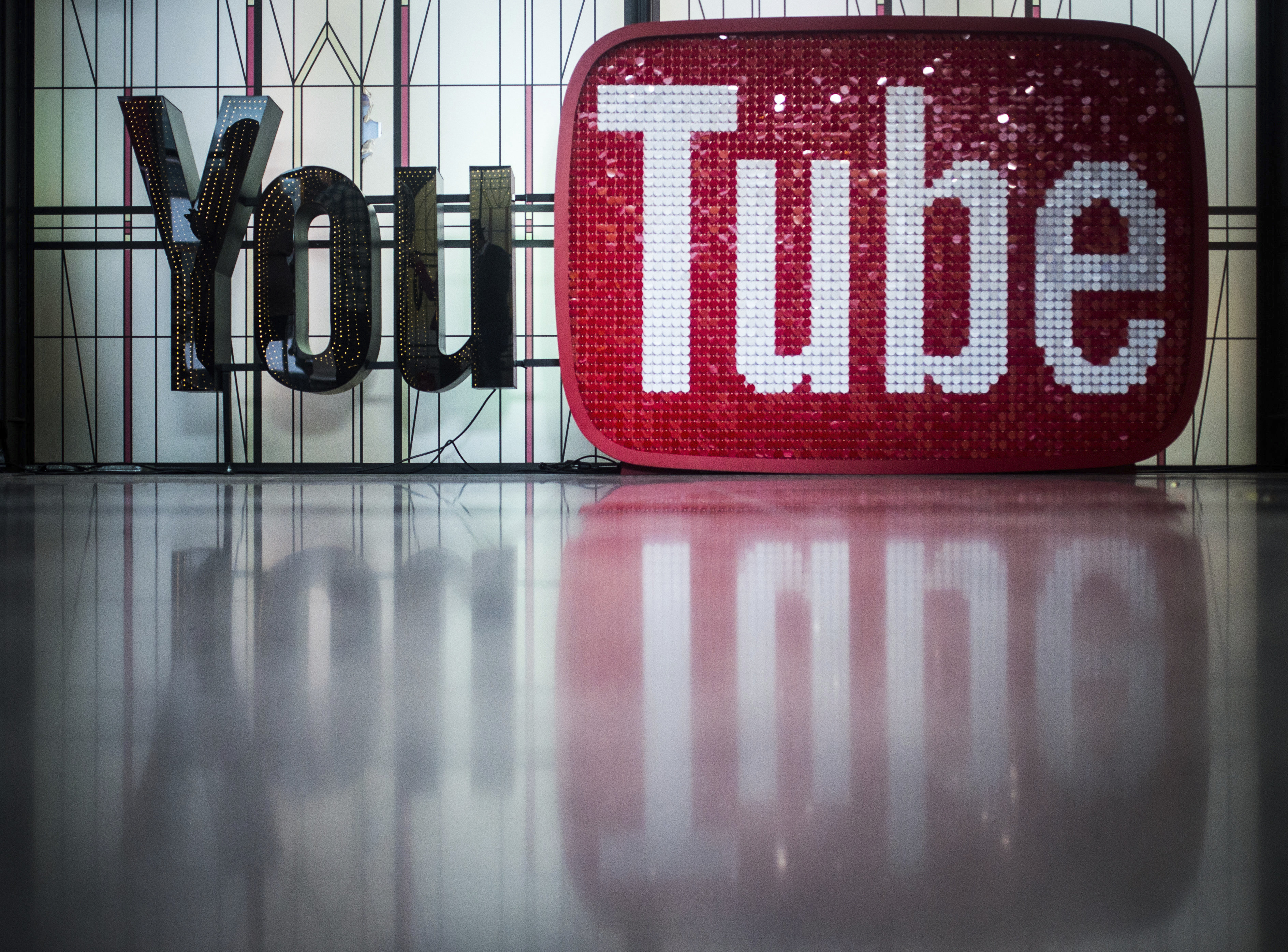 The logo of YouTube at the YouTube Space Berlin on Dec. 7, 2017. YouTube announced on Feb. 28, 2019 that it will be banning comments on videos featuring kids, responding to criticism and fears of potential predators on the video sharing platform. (Sophia Kembowski—picture-alliance/dpa/AP)