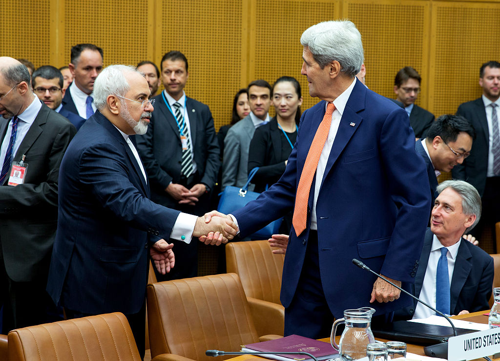 Foreign Minister of Iran, Mohammad Javad Zarif shakes hands with U.S. Secretary of State John Kerry at the last working session of E 3+3 negotiations on July 14, 2015 in Vienna, Austria. (Thomas Imo—Photothek via Getty Images)