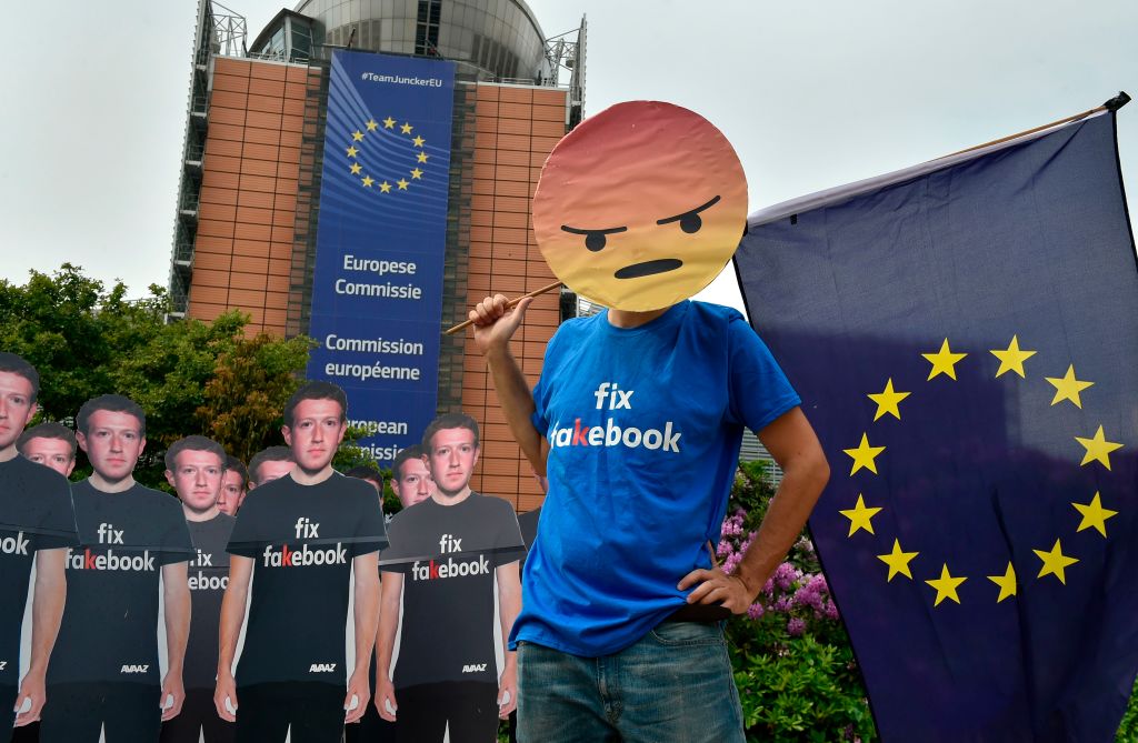 Global activists from Avaaz set up cardboard cutouts of Facebook chief Mark Zuckerberg, bearing the words  "Fix Fakebook," in front of the European Union headquarters in Brussels, on May 22, 2018. (John Thys—AFP/Getty Images)