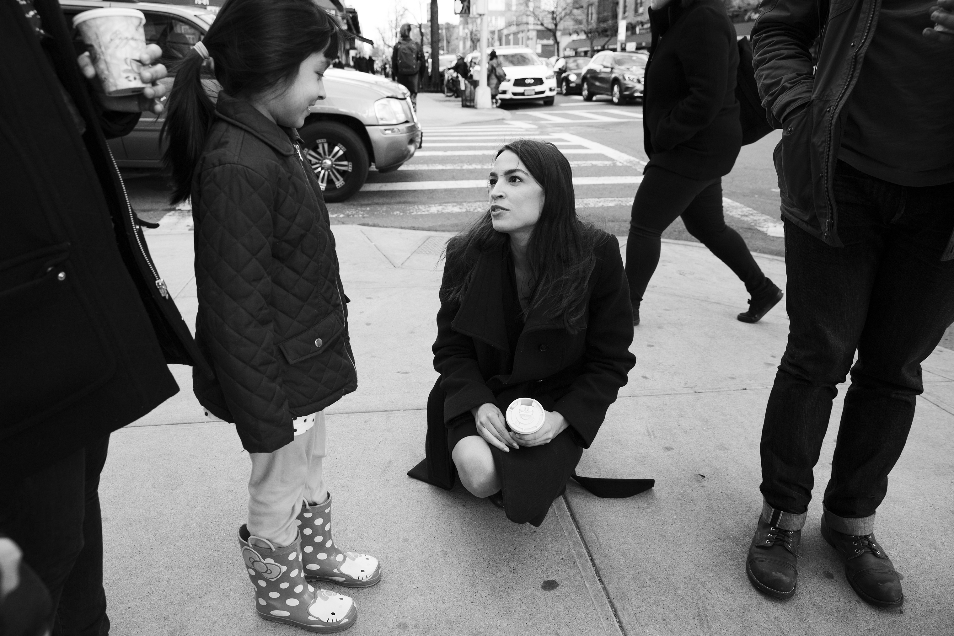 Ocasio-Cortez talks with a staff member's daughter near the office in Jackson Heights. (Krisanne Johnson for TIME)