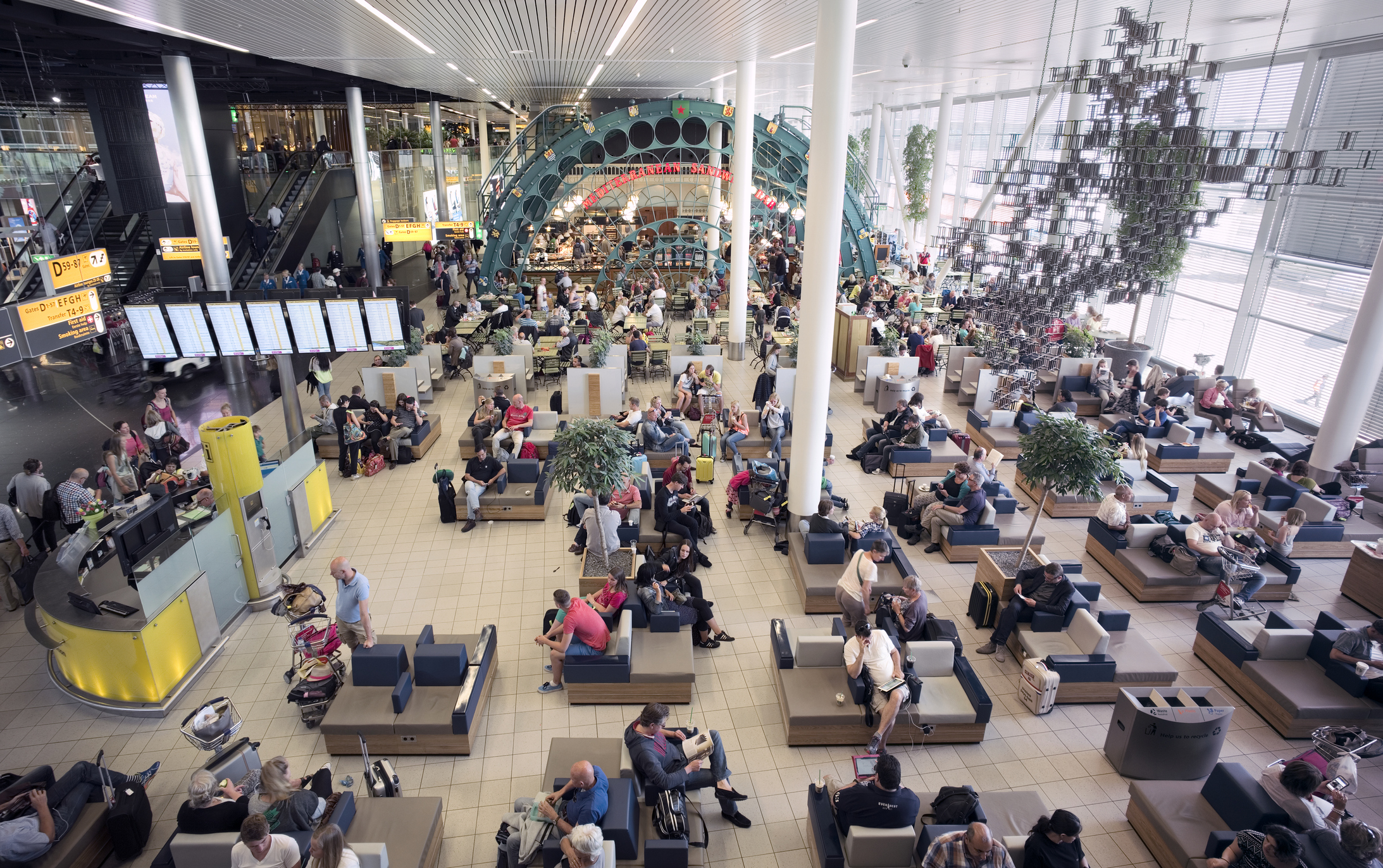 Travelers waiting for departure at one of the lounges (Schengen area) at Schiphol Airport, Amsterdam, The Netherlands. (EschCollection—Getty Images)