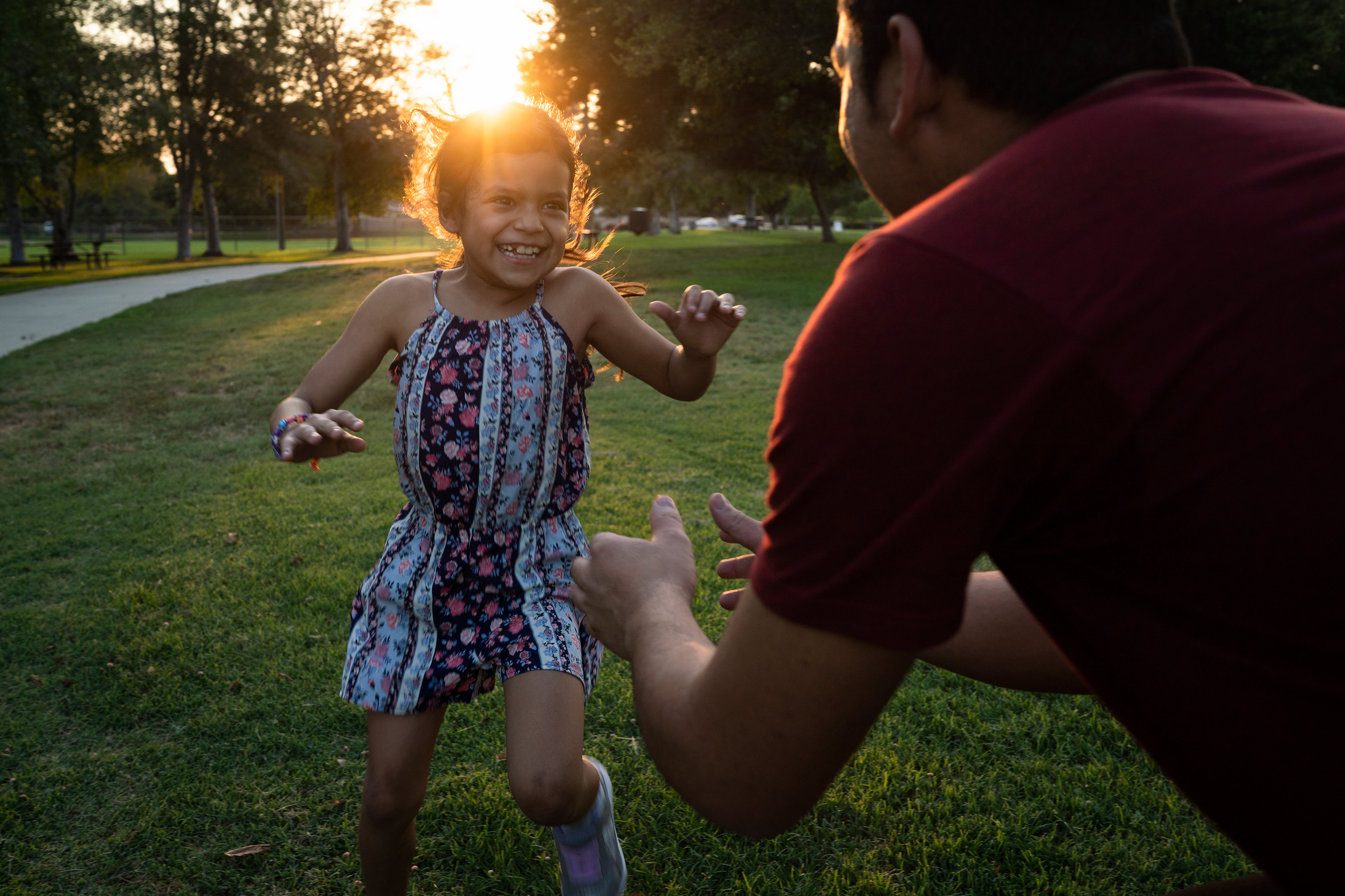 Heyli and her father play together at a park near their temporary home in Southern California. (Veronica G. Cardenas for TIME and The Texas Tribune)