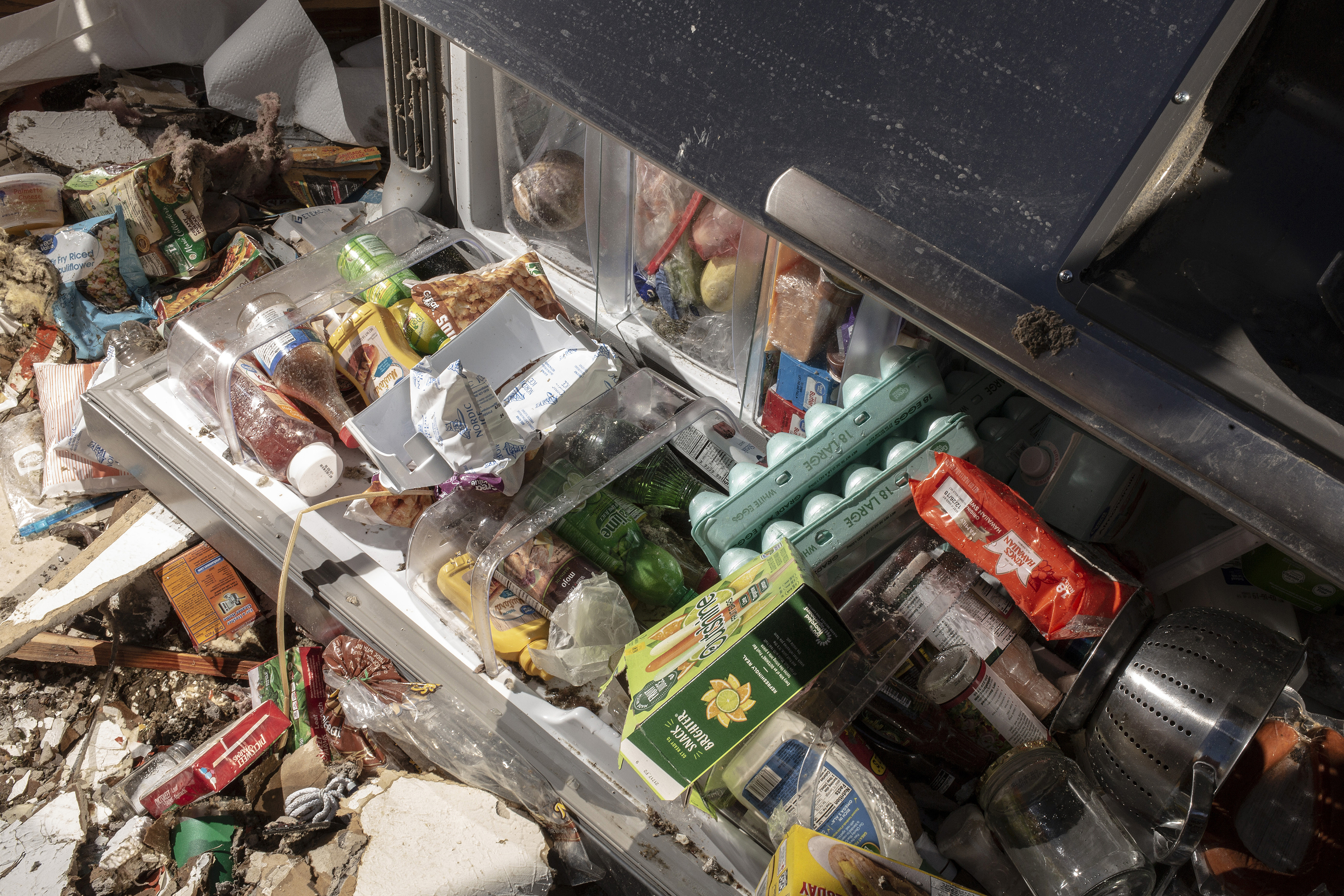 The contents of the Mattocks' refrigerator strewn on their kitchen floor after a tornado passed over killing several people and destroying homes in Beauregard, Alabama on March 4, 2019. (Bryan Anselm—Redux for TIME)
