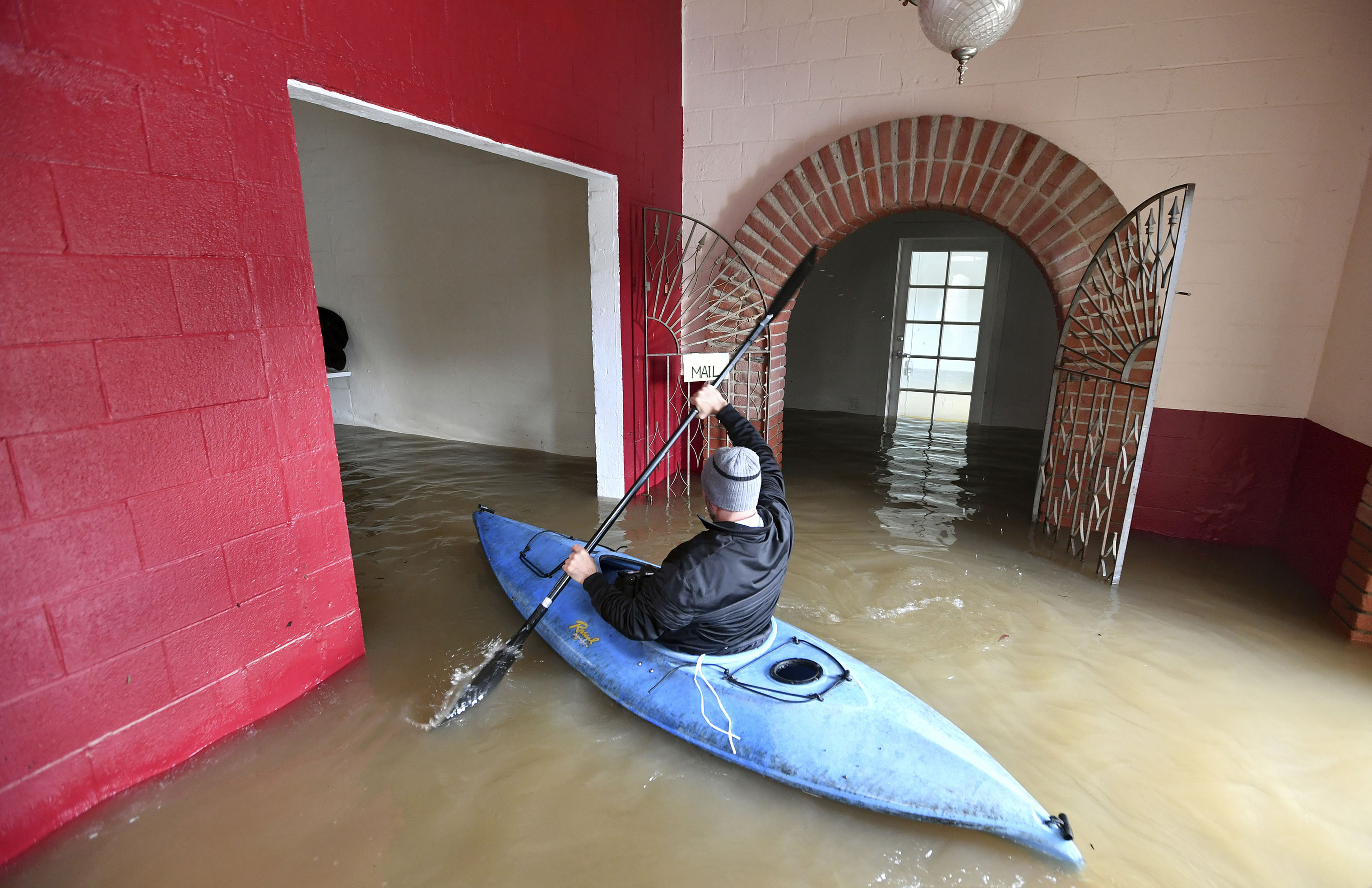 Jay Michael Tucker kayaks through the flooded Surrey Resort as the Russian River flows through it in Guerneville, Calif., on Feb. 15, 2019. (Josh Edelson—AP)