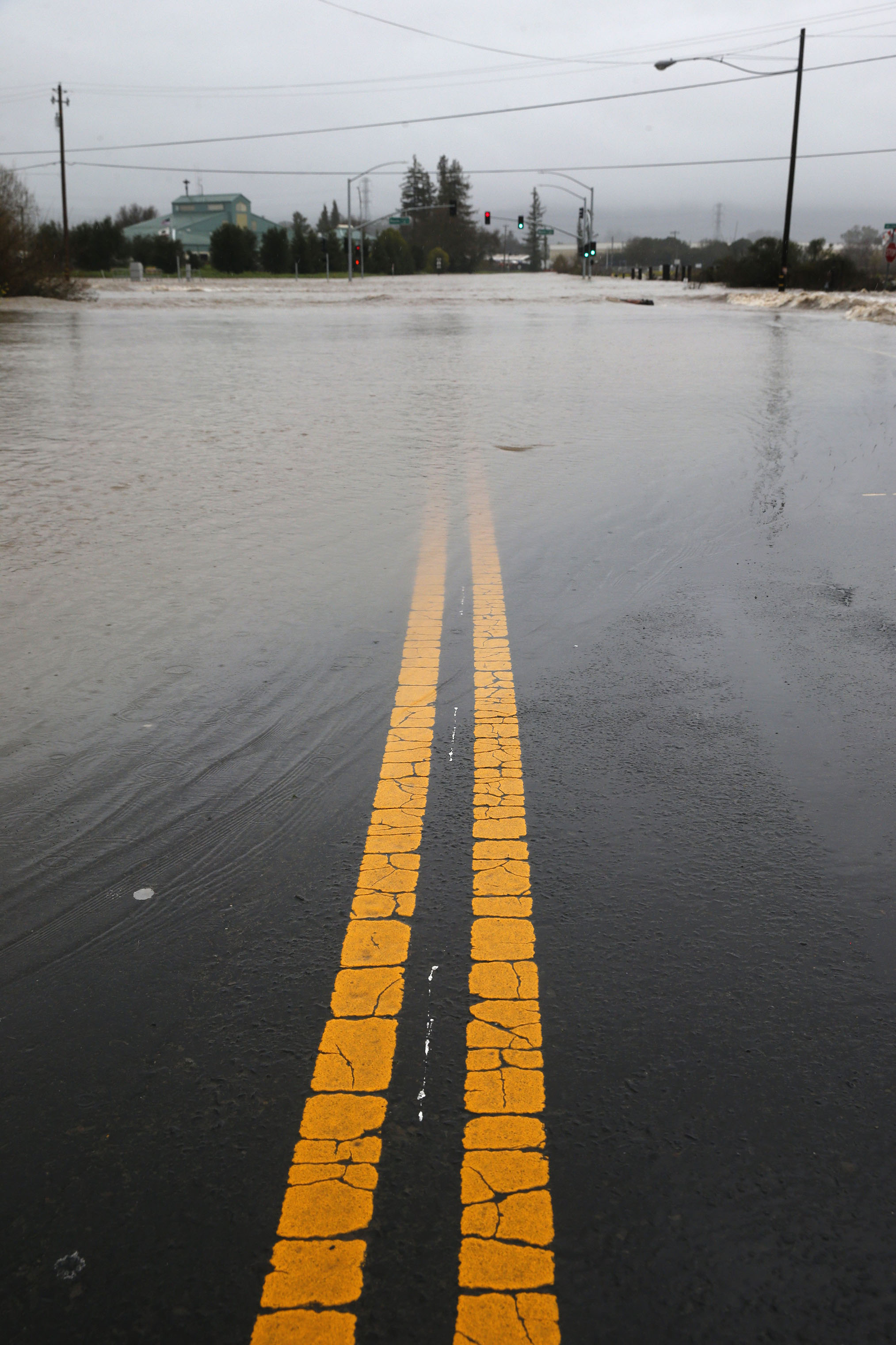 The intersection of Highways 121 and 12 are closed to traffic after the Sonoma Creek surged over its banks and flooded the roadway during the heavy rainstorm in Sonoma, California on Feb. 26, 2019. (Paul Chinn—San Francisco Chronicle/Polaris)