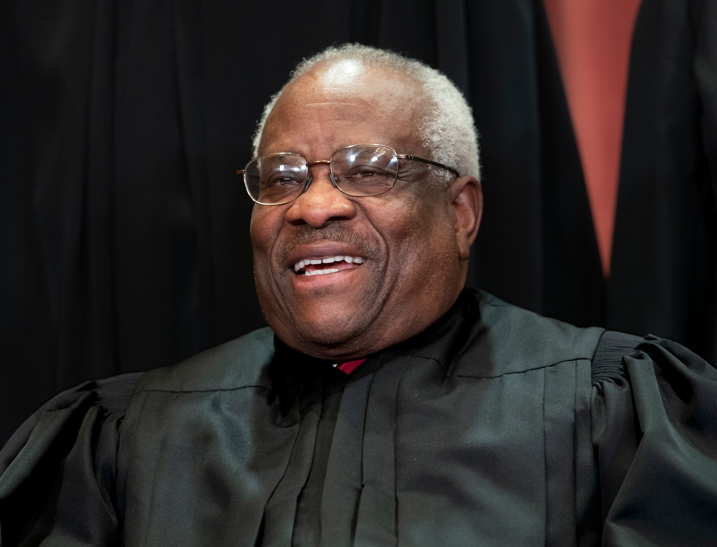 Associate Justice Clarence Thomas sits with fellow Supreme Court justices for a group portrait at the Supreme Court Building
