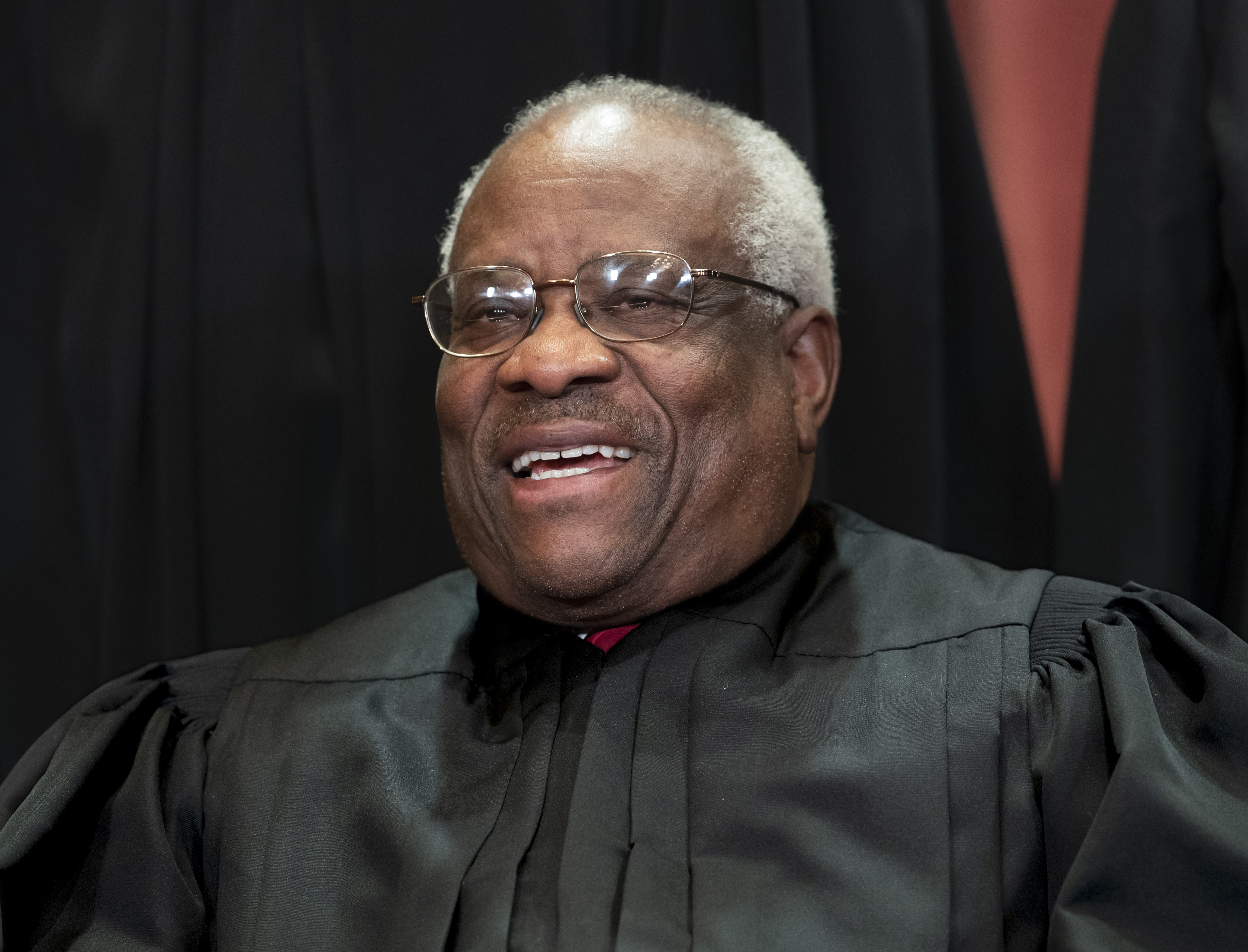 Associate Justice Clarence Thomas sits with fellow Supreme Court justices for a group portrait at the Supreme Court Building in Washington on Nov. 30, 2018. Thomas spoke at a U.S. Supreme Court argument for the first time in three years on March 20, 2019. (J. Scott Applewhite—AP)