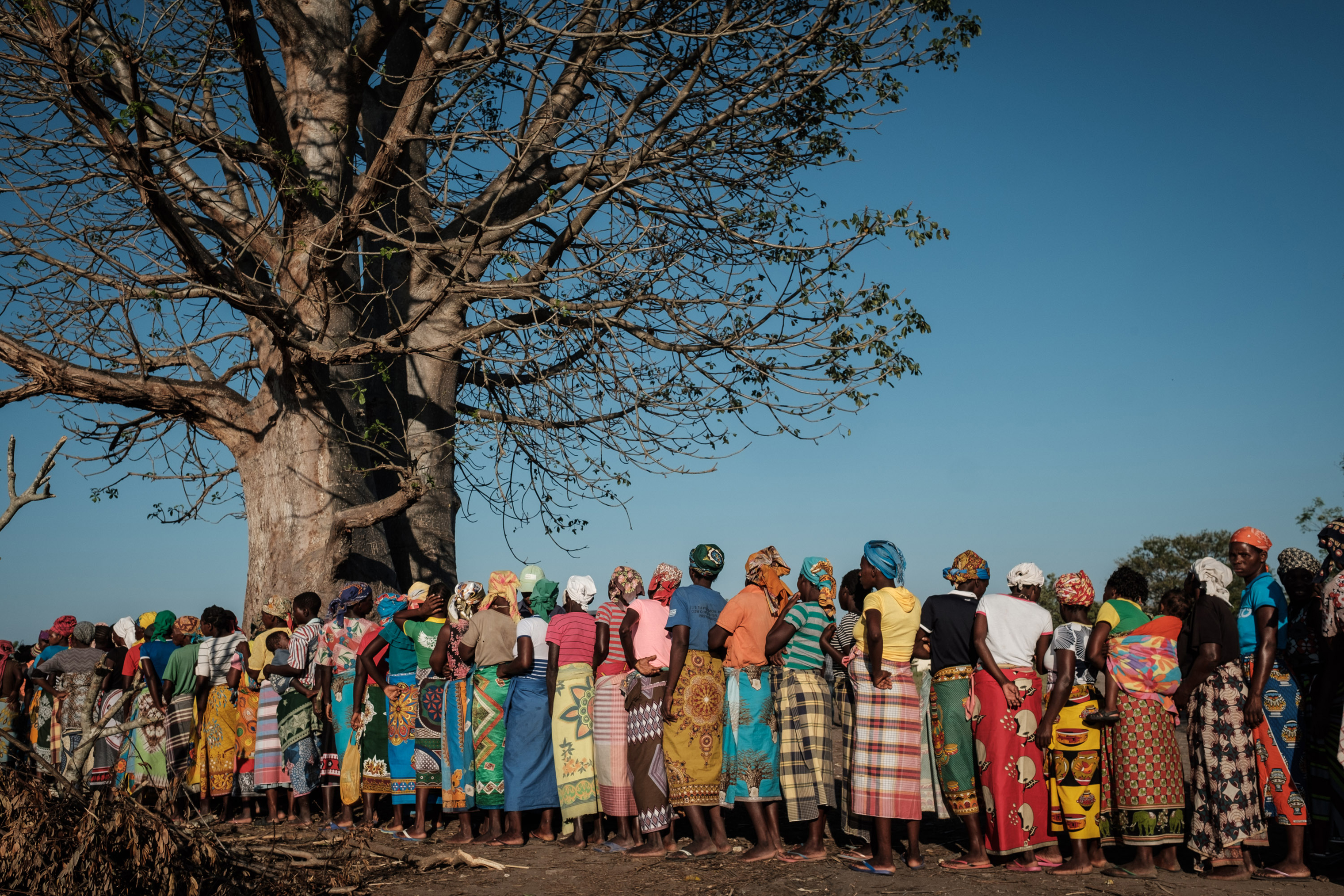 Women wait in a line to receive relief supplies from a South African relief organization in Estaquinha, Mozambique, on March 26, 2019. (Yasuyoshi Chiba—AFP/Getty Images)