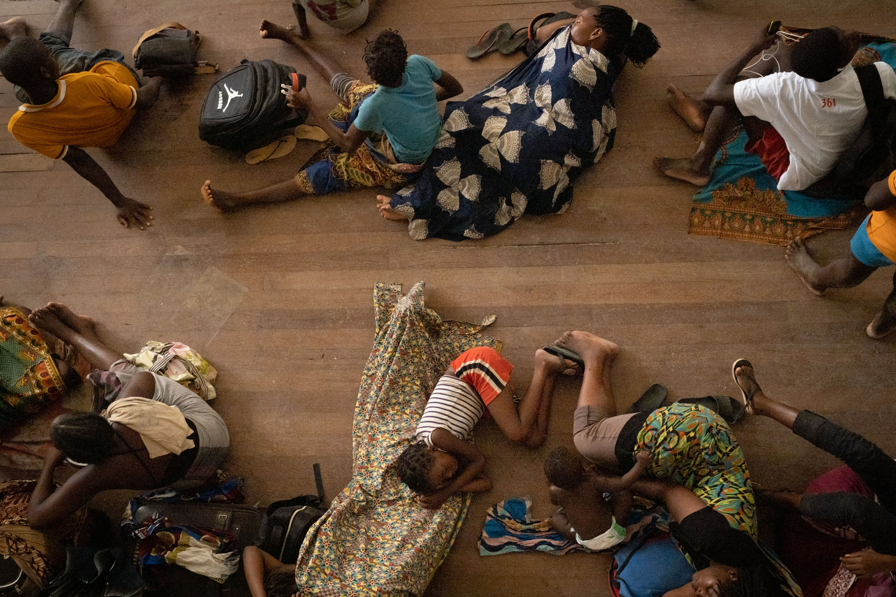 People from Buzi take shelter in the Samora M. Machel secondary school in Beira, Mozambique, on March 21, 2019, following the devastation caused by Cyclone Idai. (Yasuyoshi Chiba—AFP/Getty Images)