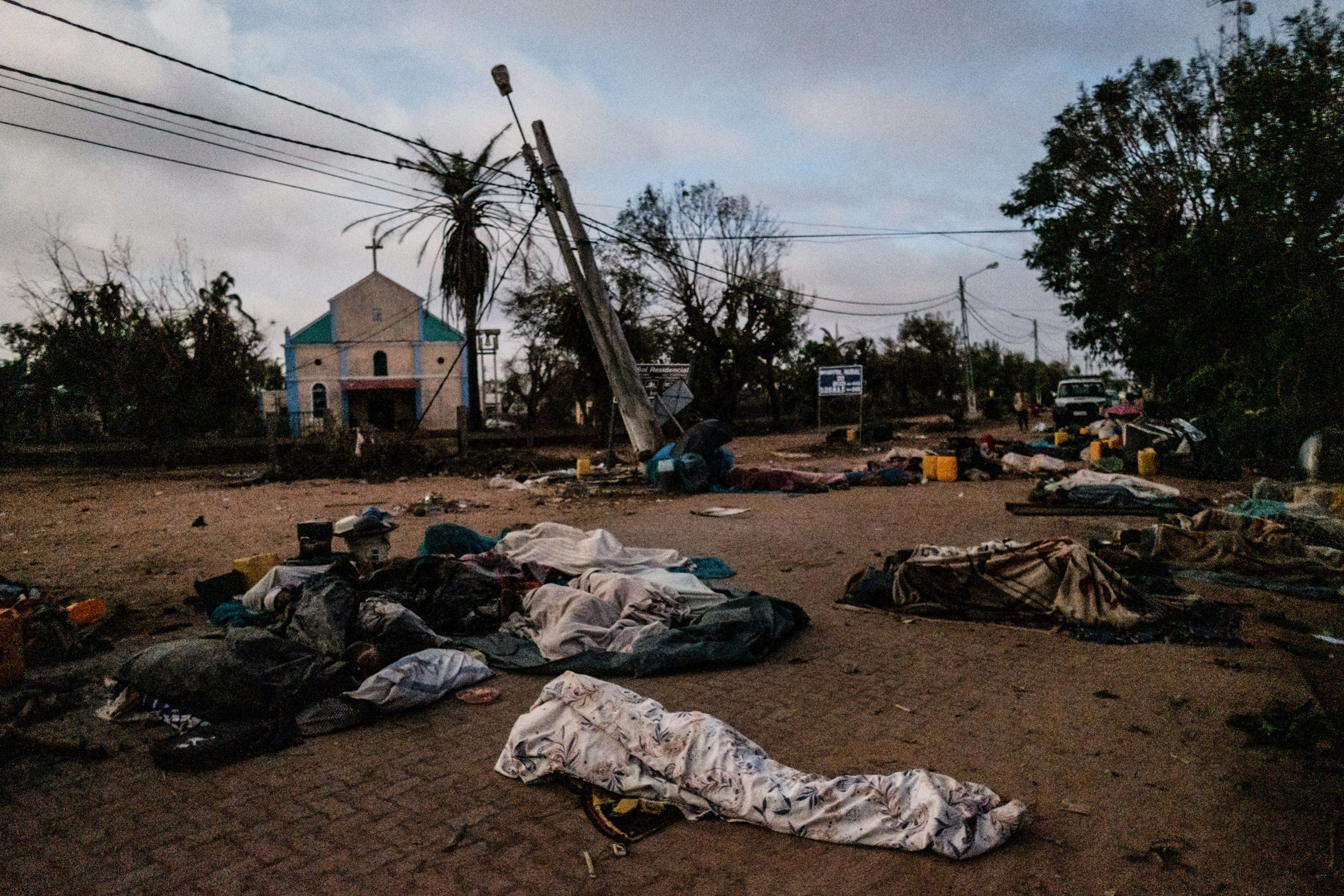 People who lost their home after cyclone Idai hit sleep on a street in Buzi, Mozambique, on March 23, 2019. (Yasuyoshi Chiba—AFP/Getty Images)