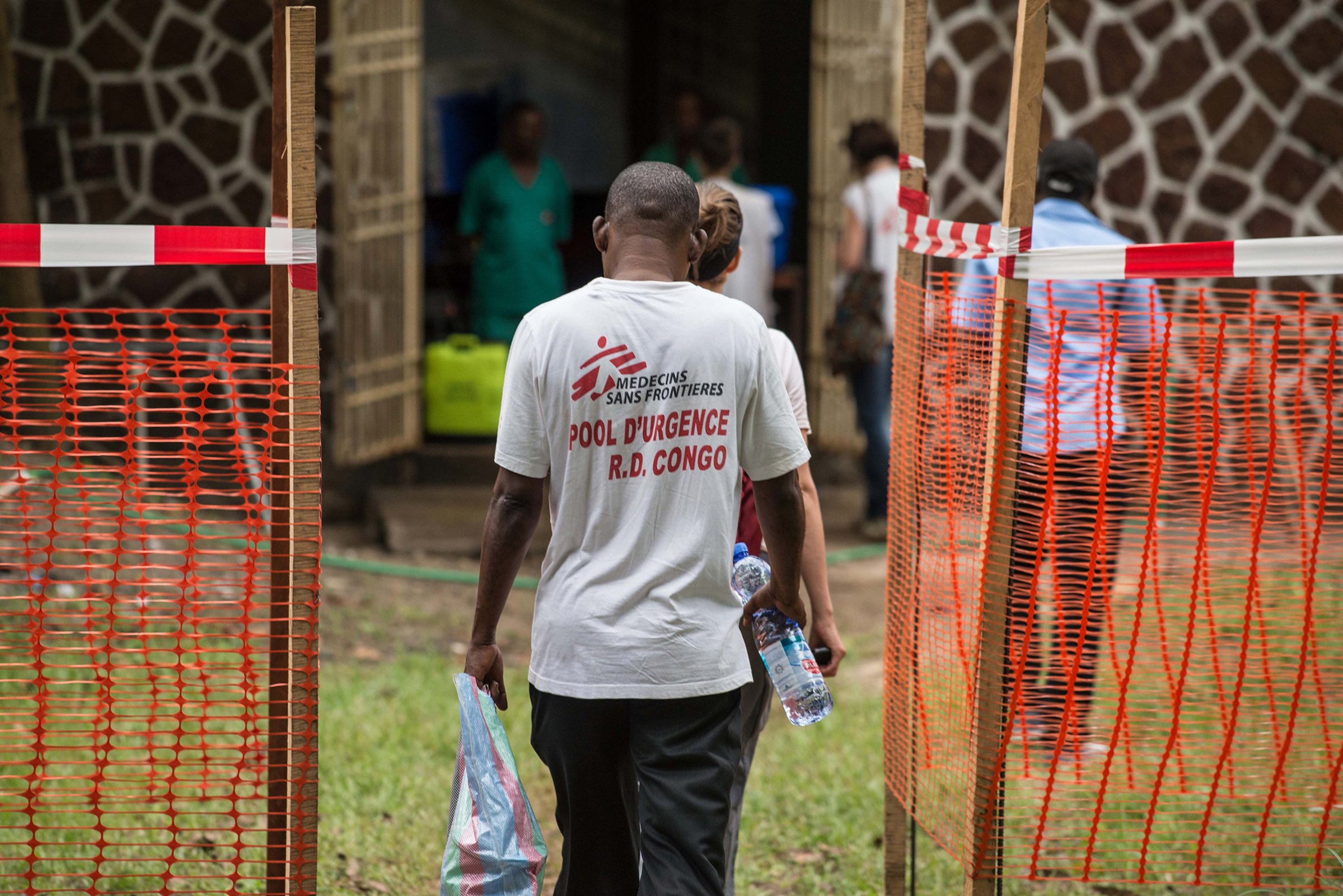 Médecins sans frontière team members walk through an Ebola security zone in Mbandaka, Democratic Republic of Congo, on May 20, 2018