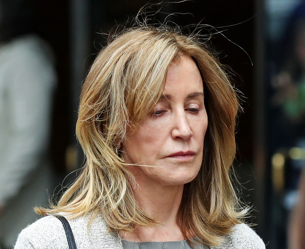 Actress Felicity Huffman leaves the John Joseph Moakley United States Courthouse in Boston on May 13, 2019. Huffman was among 50 people charged in March as part of Operation Varsity Blues, which found that wealthy parents had allegedly paid bribes to get their children falsely certified as athletic recruits at elite colleges and universities, or to facilitate cheating on their kids SAT and ACT scores. Assistant US Attorney Eric Rosen said, as part of a plea agreement, he will be seeking four months in prison and a $20,000 fine for Huffman. (David L. Ryan—Boston Globe/Getty Images)