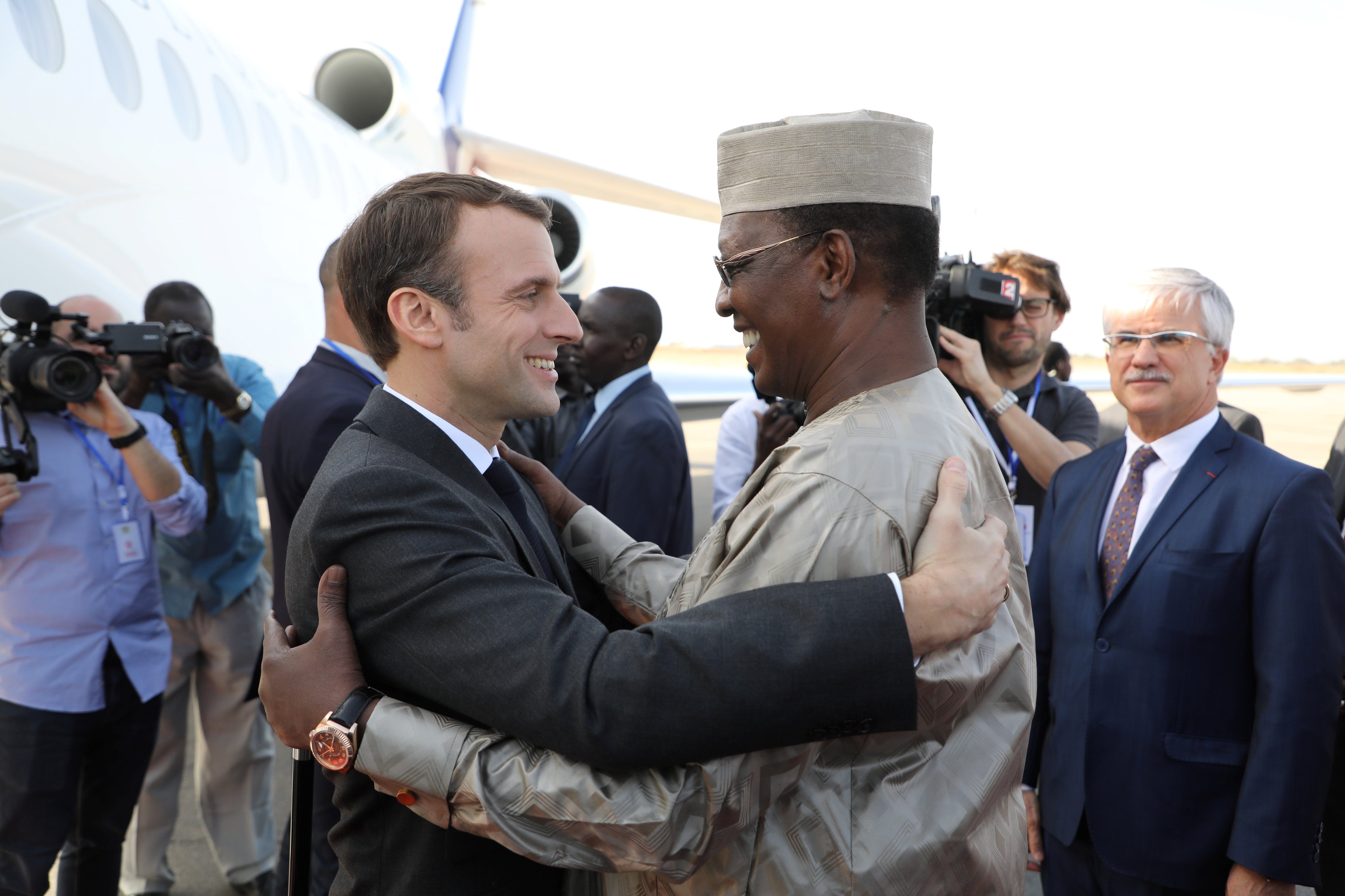 France's president Emmanuel Macron (L) is welcomed by Chad's president Idriss Deby upon his arrival at the international airport of N'Djamena on December 22, 2018. (Ludovic Marin—AFP/Getty Images)