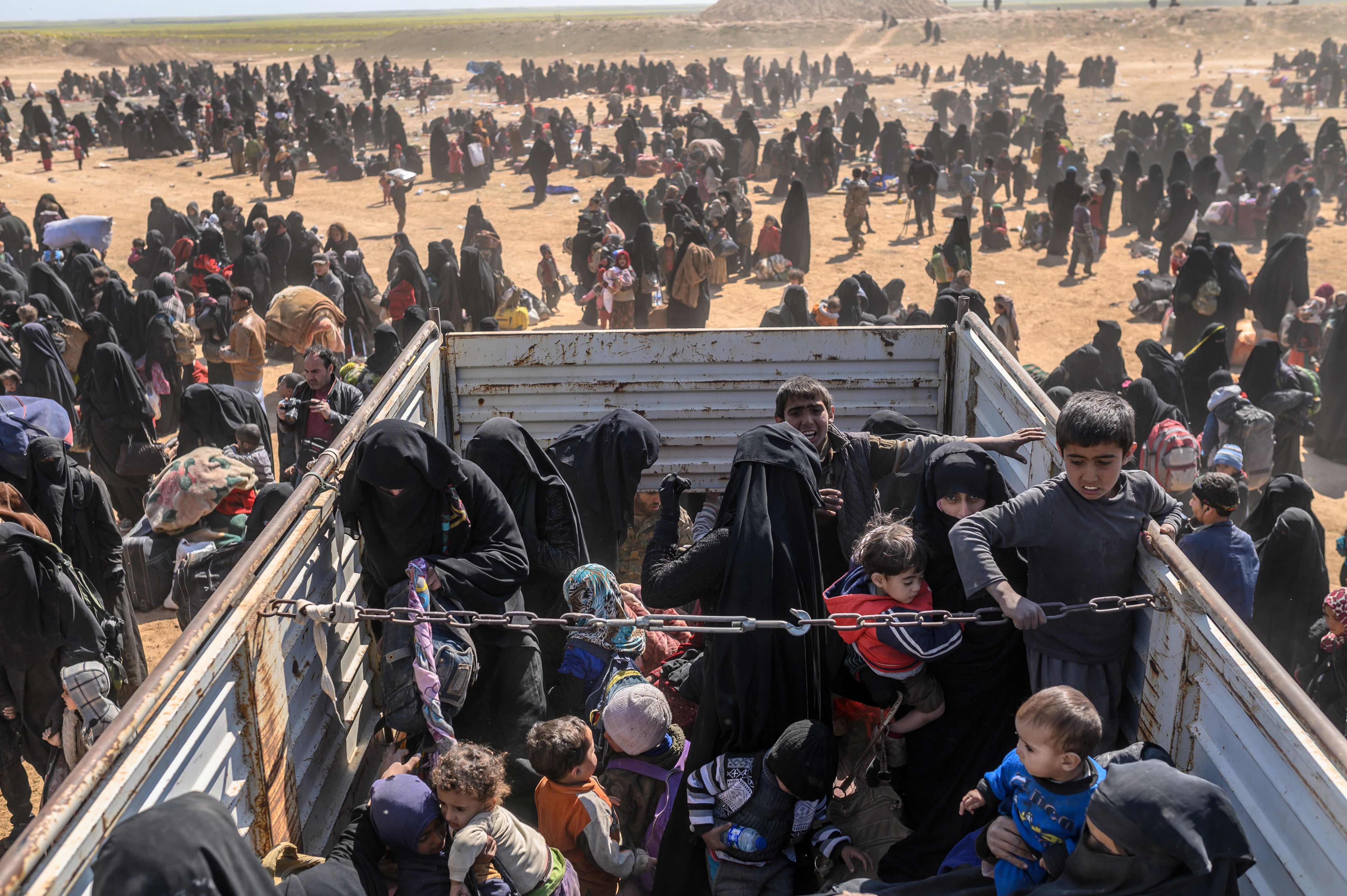 Civilians evacuated from Baghouz wait at a screening area in the eastern Syrian province of Deir Ezzor on March 6, 2019. (Bulent Kilic—AFP/Getty Images)