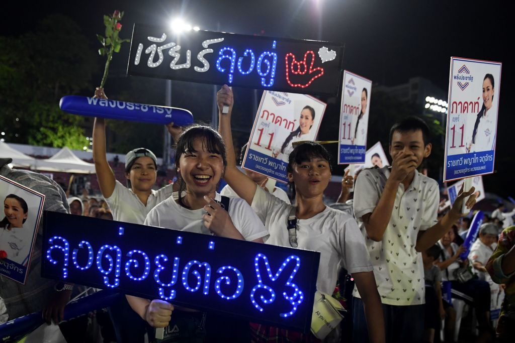 Supporters of the Phalang Pracharat party hold signs during the party's final major campaign rally in Bangkok on March 22, 2019 (Lillian Suwanrumpha—AFP/Getty Images)