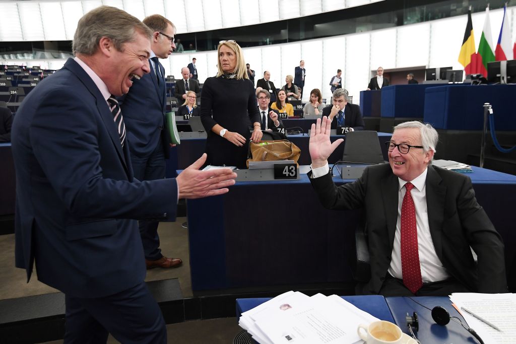 Former UK Independence Party (UKIP) leader, Brexit campaigner and member of the European Parliament Nigel Farage (L) speaks with European Commission President Jean-Claude Juncker at the European Parliament on March 27, 2019 in Strasbourg, eastern France. (Frederick Florin—AFP/Getty Images)