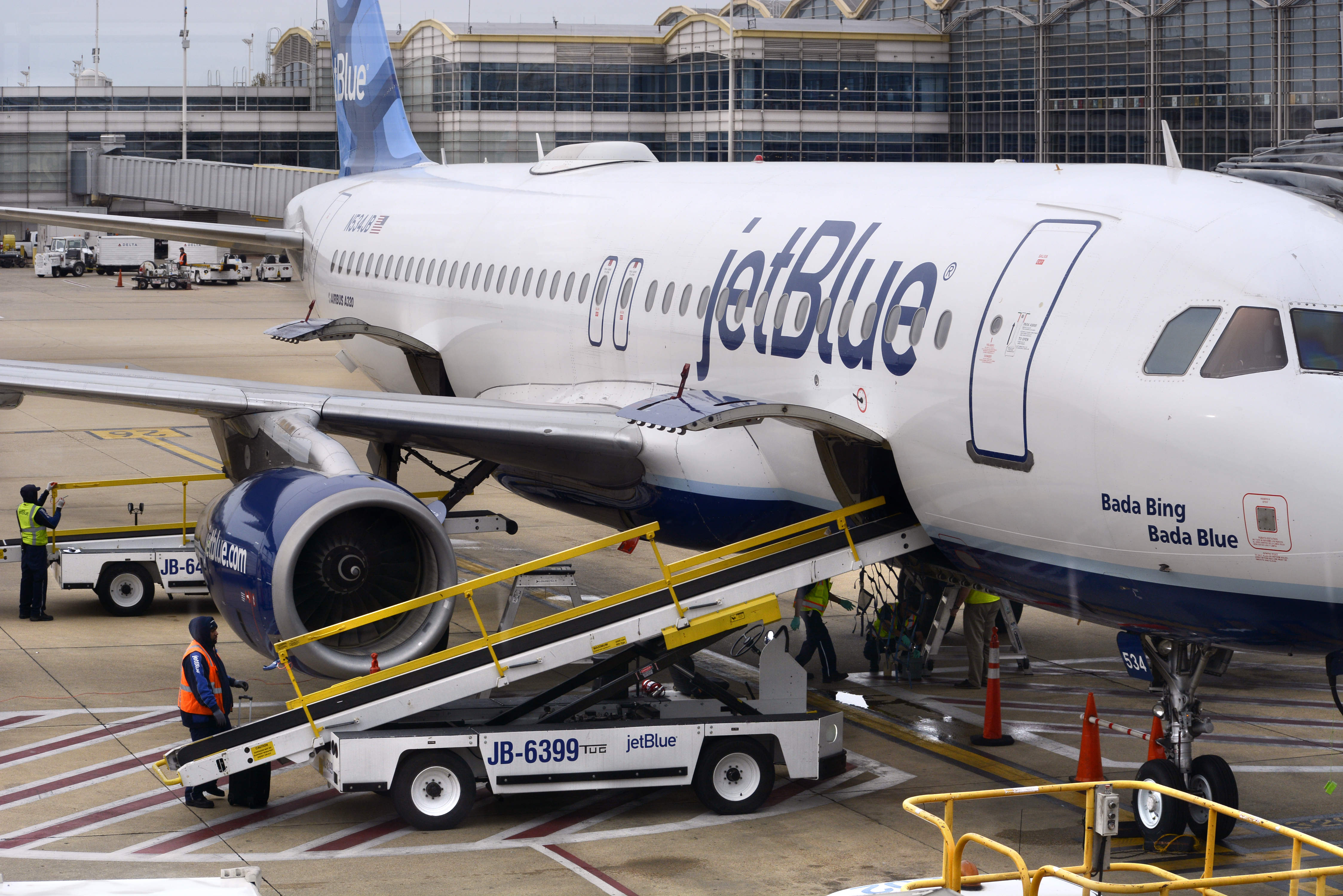 A JetBlue jet is serviced at a gate at the Ronald Reagan Washington National Airport in Washington, D.C. on April 24, 2018. (Robert Alexander—Getty Images)