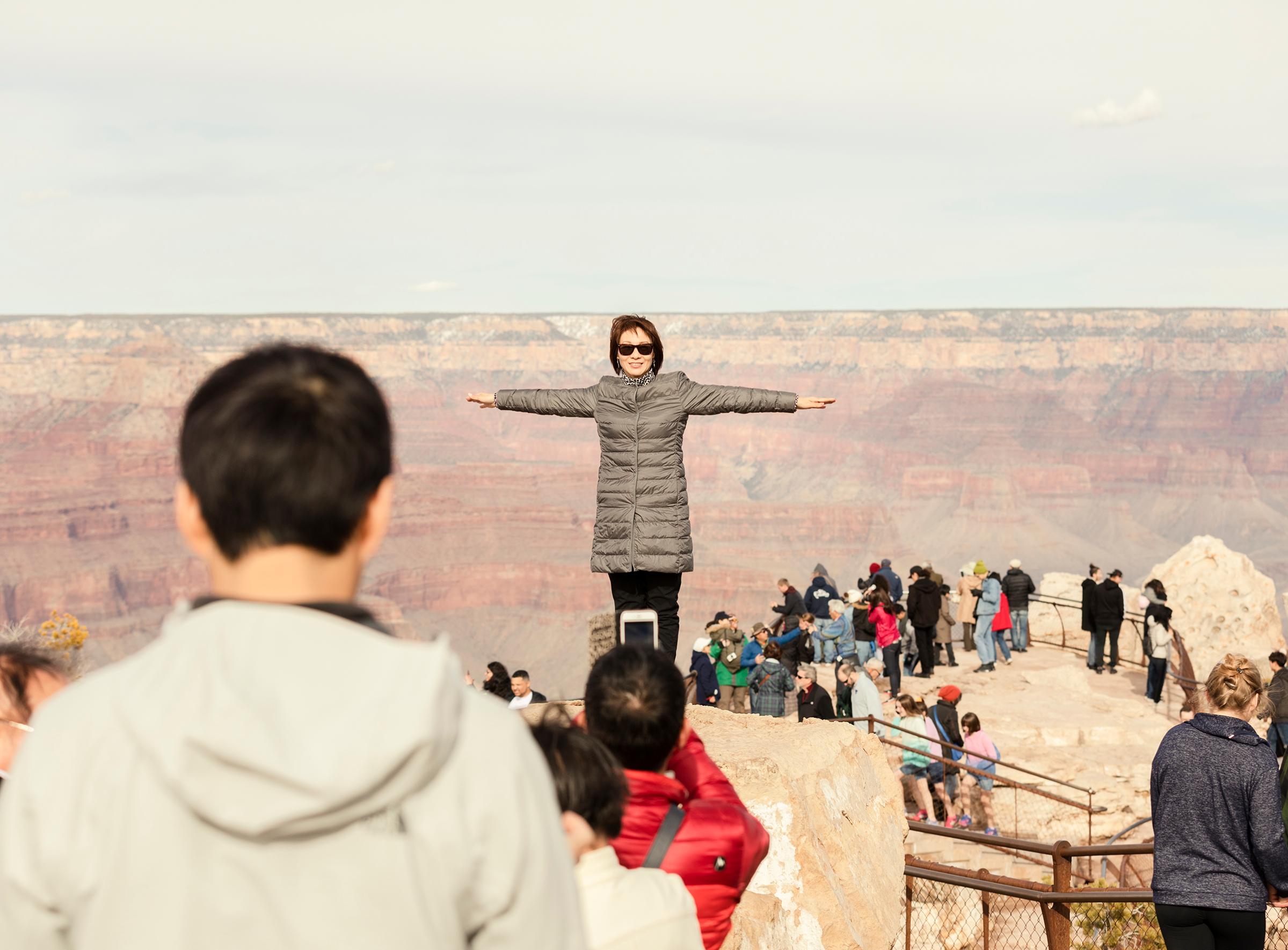 A visitor poses for a photo at Grand Canyon National Park