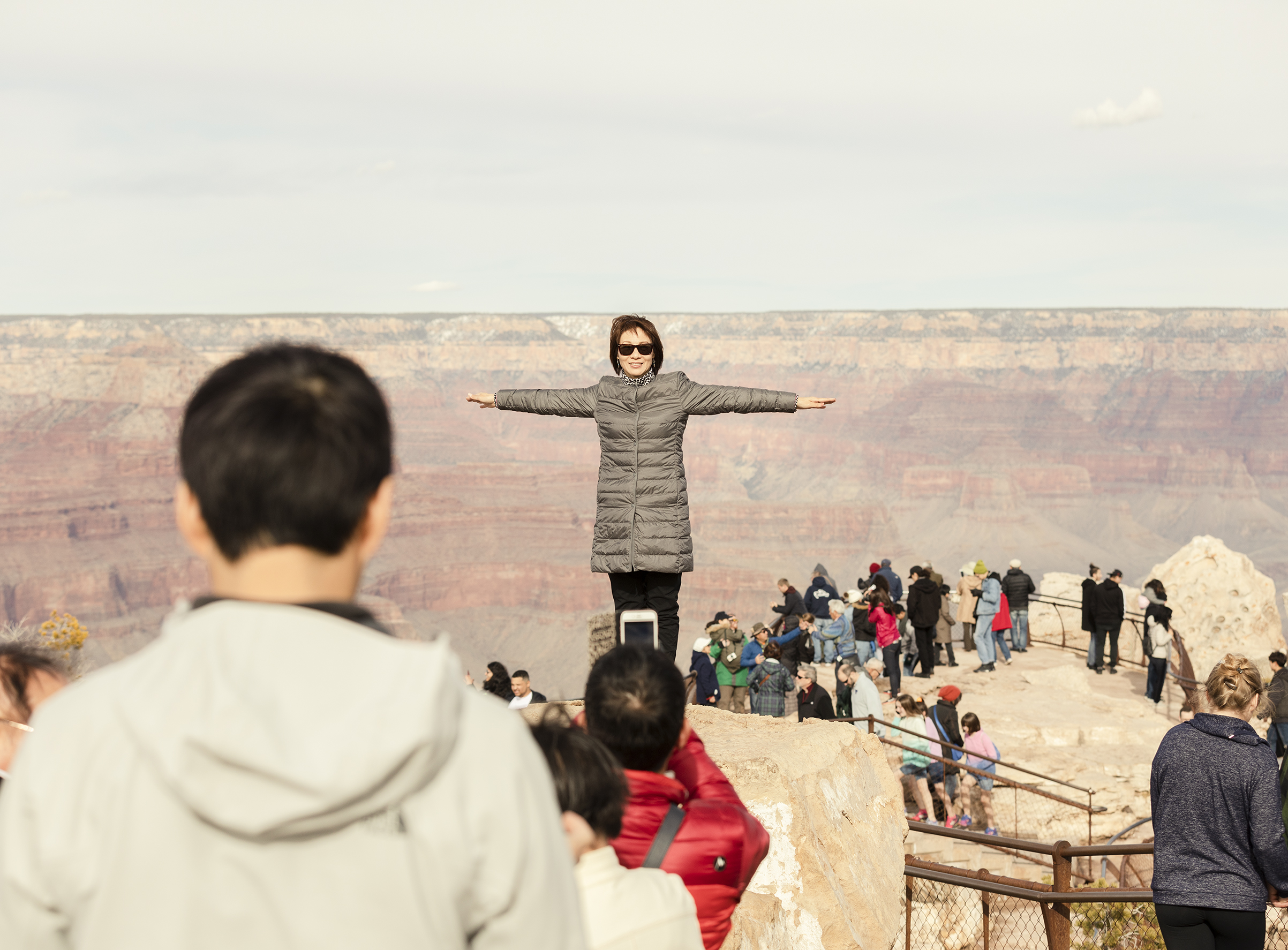 A visitor poses for a photo at Grand Canyon National Park on March 1 (Jesse Rieser for TIME)