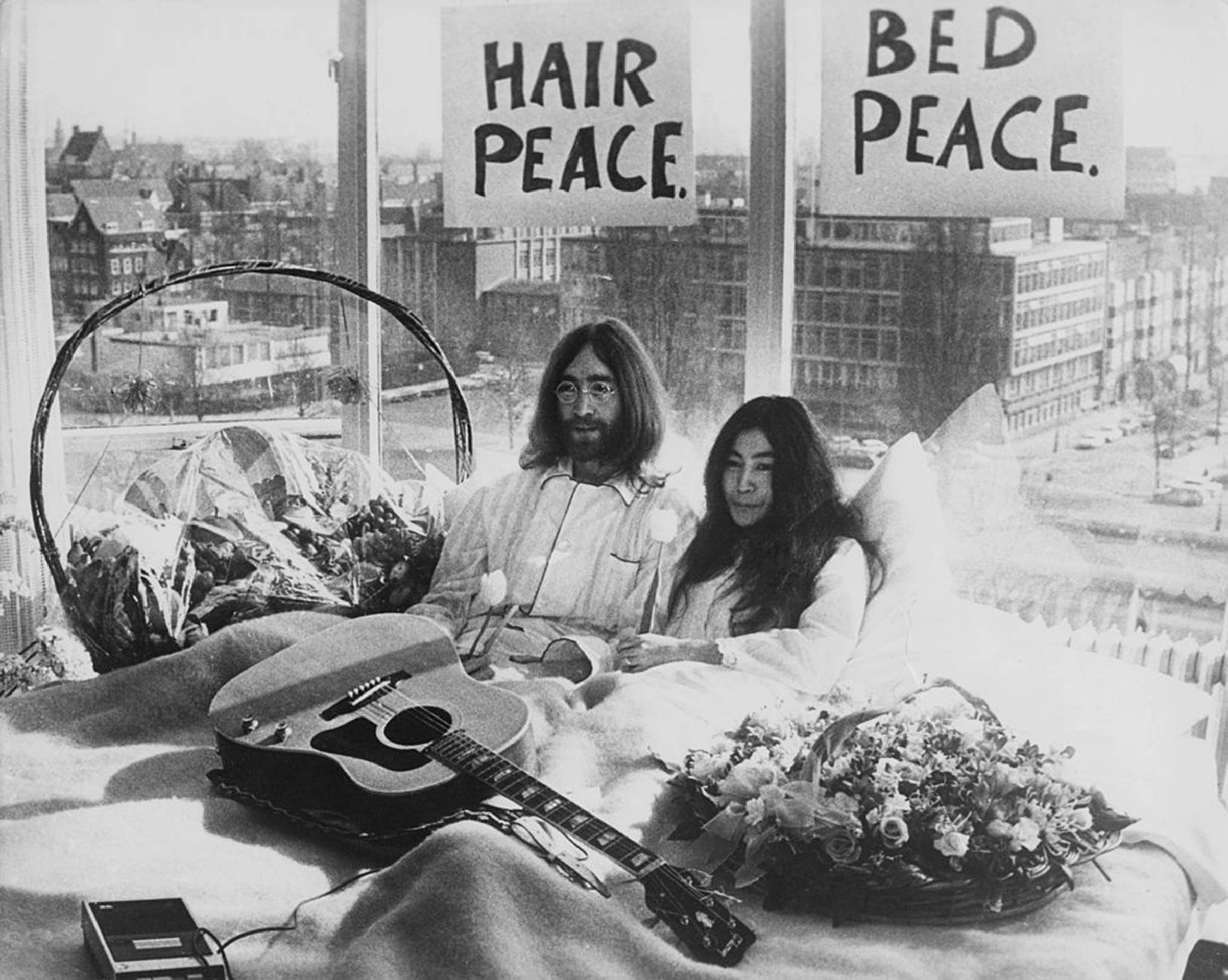 Newly-weds John Lennon of The Beatles and artist Yoko Ono kick-off a bed-in for peace on Mar. 25, 1969, in their suite at the Hilton Amsterdam in The Netherlands. (Keystone/Hulton Archive—Getty Images)