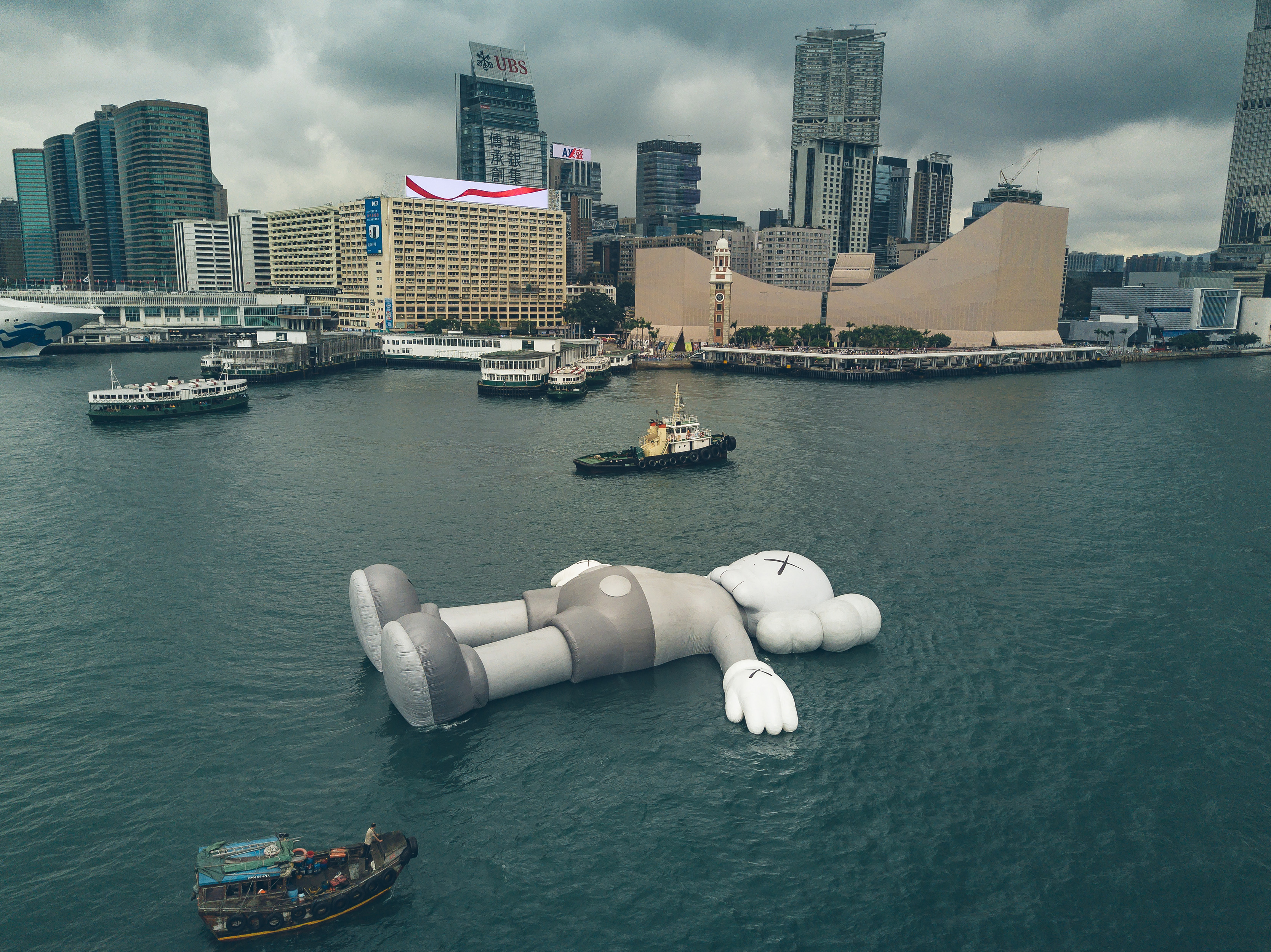 KAWS' sculpture 'Companion' floats in Victoria Harbor in Hong Kong on March 22, 2019. (Harimao Lee)