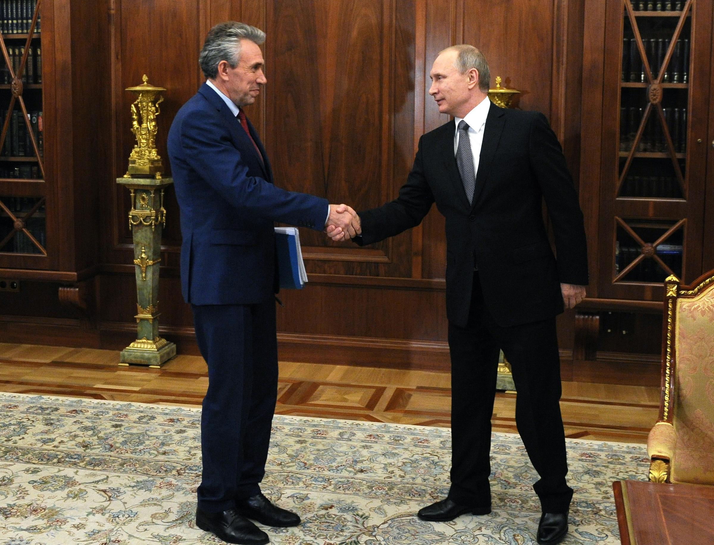 Then-Chairman of Russia’s Vnesheconombank, Sergey Gorkov, left, meets Russian President Vladimir Putin at the Kremlin on Aug. 3, 2016.