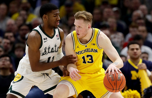 Ignas Brazdeikis #13 of the Michigan Wolverines dribbles the ball while being guarded by Aaron Henry #11 of the Michigan State Spartans in the second half during the championship game of the Big Ten Basketball Tournament at the United Center in Chicago, Illinois on March 17, 2019. (Jonathan Daniel—Getty Images)