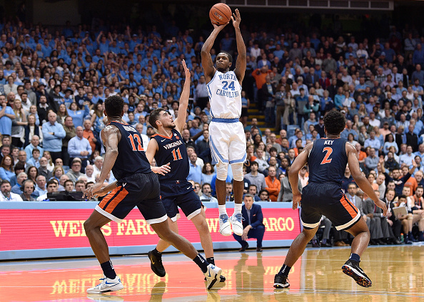 Kenny Williams #24 of the North Carolina Tar Heels takes a three-point shot against the Virginia Cavaliers during their game at the Dean Smith Center in Chapel Hill, North Carolina on February 11, 2019 .