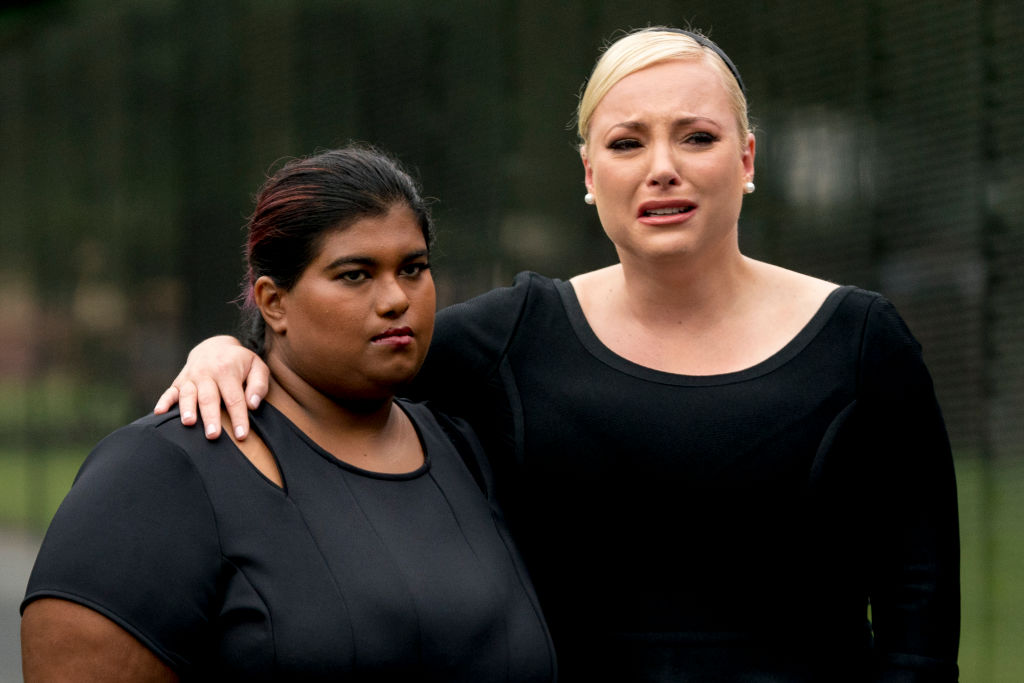 Bridget McCain and Meghan McCain, daughters of, Sen. John McCain, R-Ariz., watch as Cindy McCain lays a wreath at the Vietnam Veterans Memorial during a funeral procession to carry the casket of her husband from the U.S. Capitol to National Cathedral for a Memorial Service on September 1, 2018 in Washington, D.C. (Pool—Getty Images)