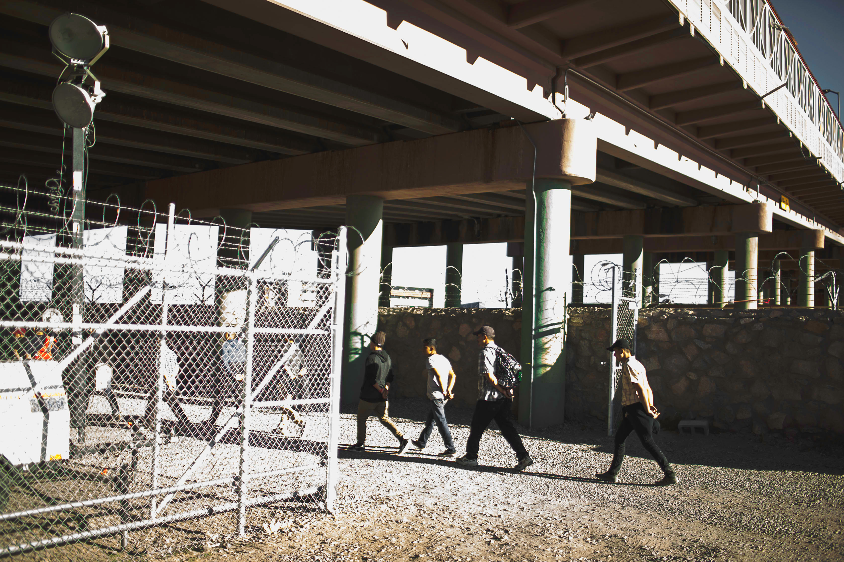 Migrants apprehended by the U.S. Customs and Border patrol are taken to a tent set up underneath the Paso Del Norte Bridge as they await processing in El Paso, Texas, on March 28, 2019. (Jared Moossy for TIME)