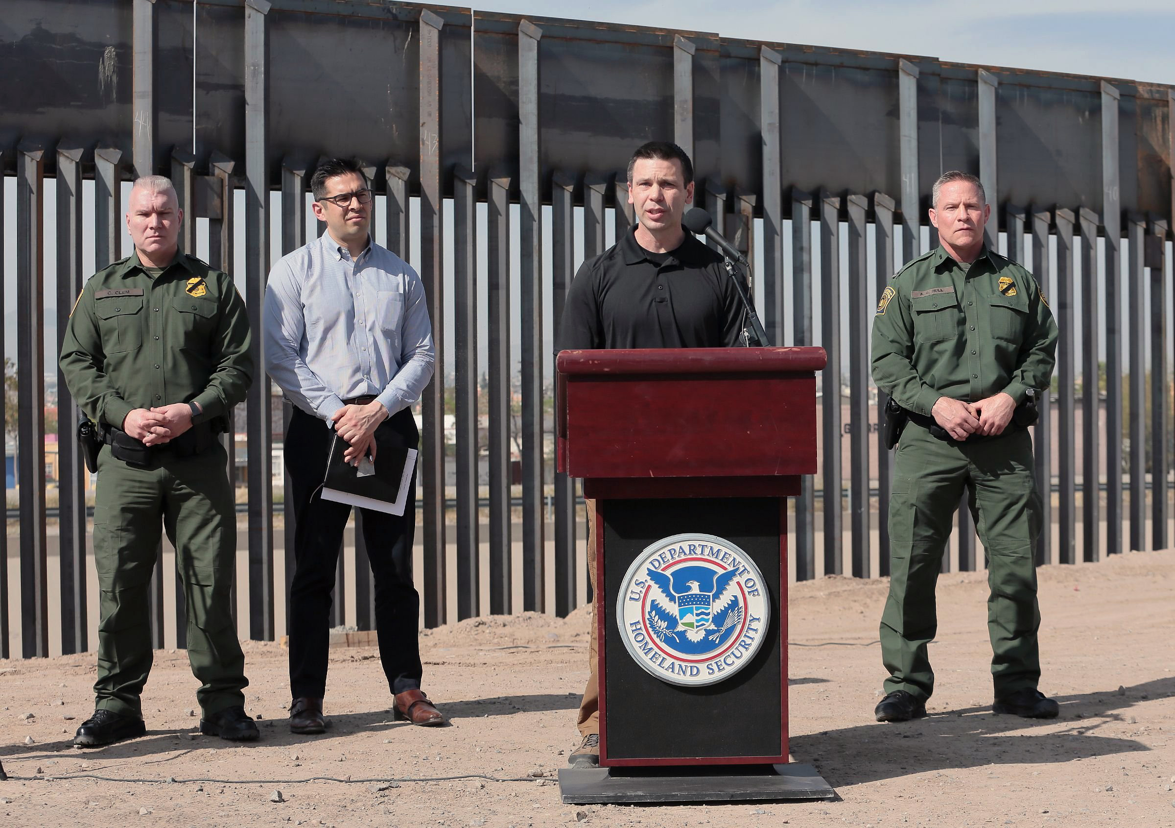U.S. Customs and Border Protection Commissioner Kevin K. McAleenan, with the bollard border fence in the background, held a press conference in El Paso, Texas, on Mar. 27, 2019. McAleenan said the border has hit its 