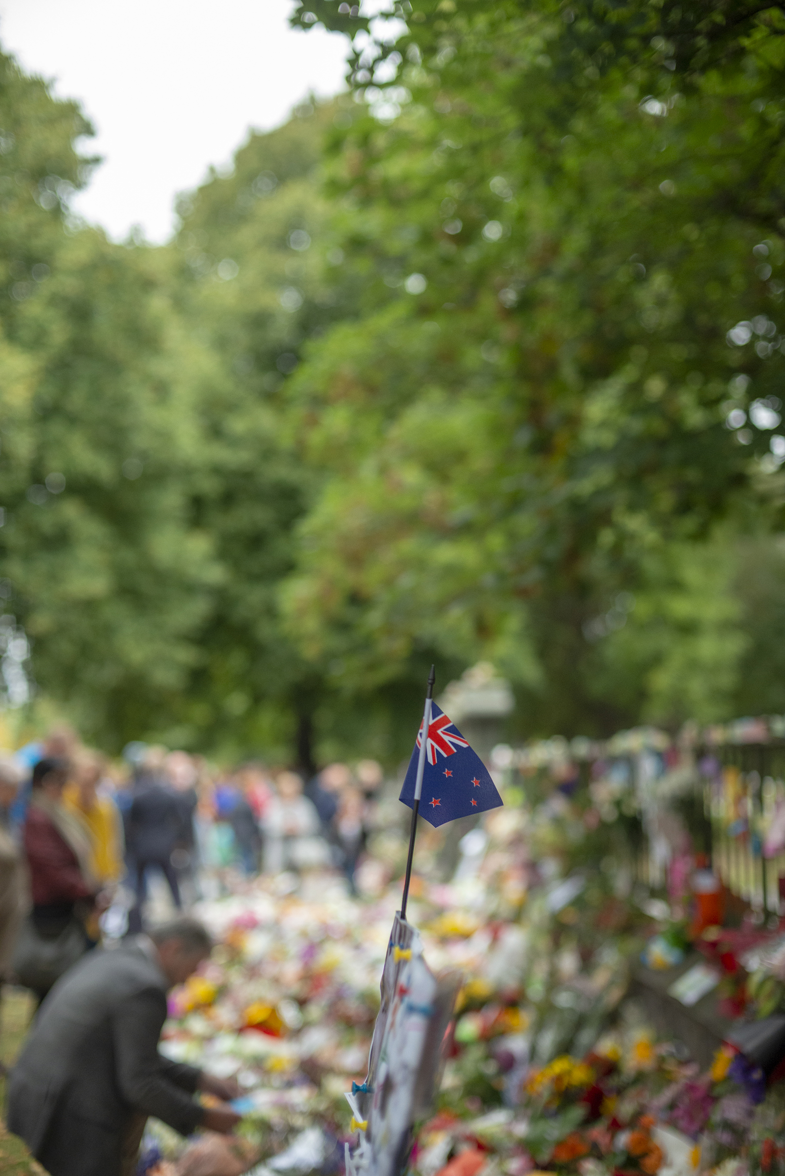 A New Zealand flag stand amidst the tributes to the shooting victims in Christchurch. (Virginia Woods-Jack for TIME)