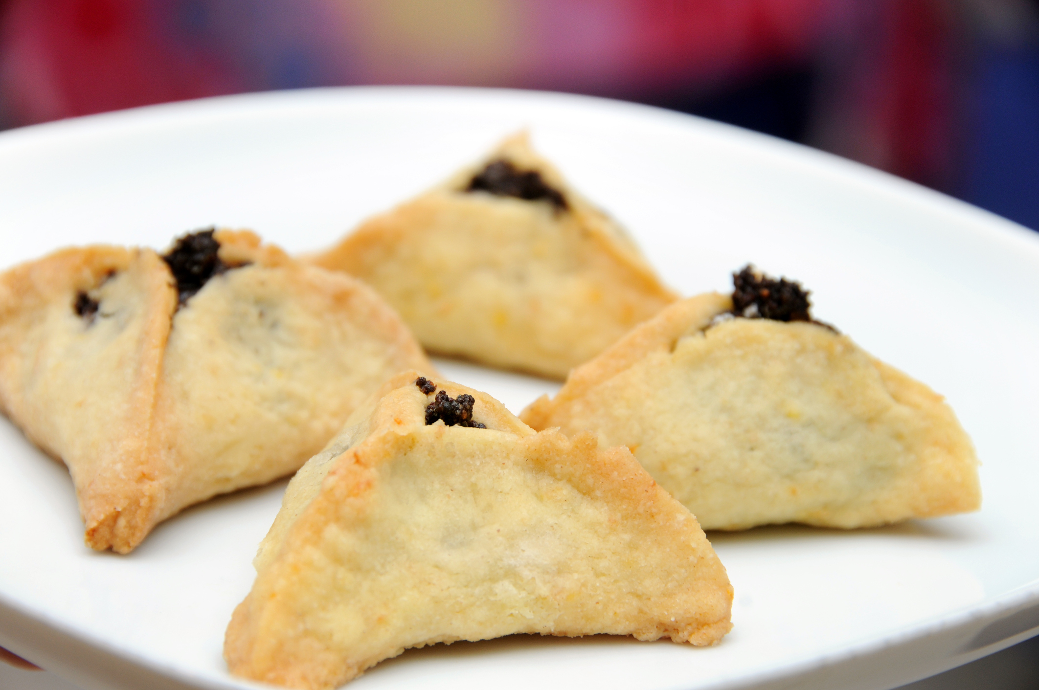 A plate of hamentaschen cookies filled with poppyseeds. (Yula—Getty Images/iStockphoto)