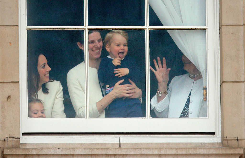 Prince George of Cambridge being held up at a window of Buckingham Palace by his nanny to watch Trooping the Colour on June 13, 2015 in London, England. (Max Mumby/Indigo&mdash;Getty Images)
