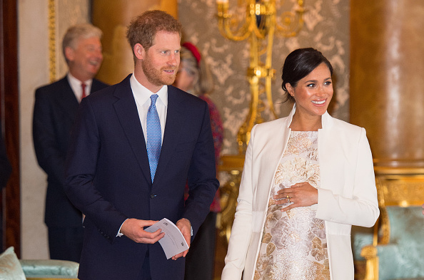 Meghan, Duchess of Sussex and Prince Harry, Duke of Sussex attend a reception to mark the fiftieth anniversary of the investiture of the Prince of Wales at Buckingham Palace in London on March 5, 2019. (Dominic Lipinski—WPA Pool/Getty Images)