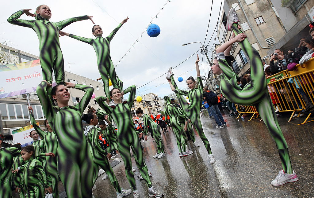 Israeli acrobats entertain the crowd in costumes during a parade celebrating the Jewish festival of Purim on March 01, 2010 in Holon near Tel Aviv. (JACK GUEZ—AFP/Getty Images)