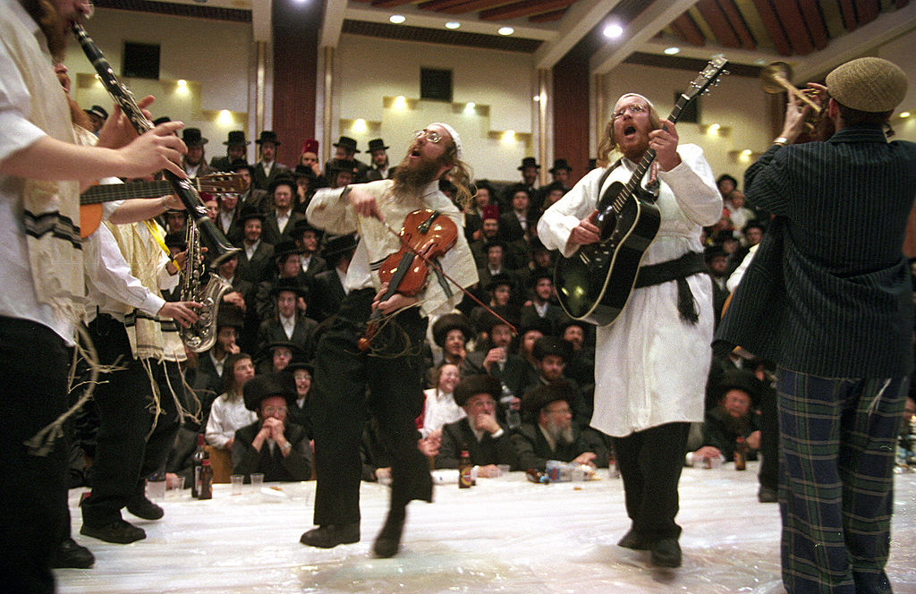 Ultra Orthodox Jews from the Tzanz Hassidim group perform a Purim play at the synagogue in Netanya, Israel, north of Tel Aviv on March 14, 2006. (MENAHEM KAHANA—AFP/Getty Images)
