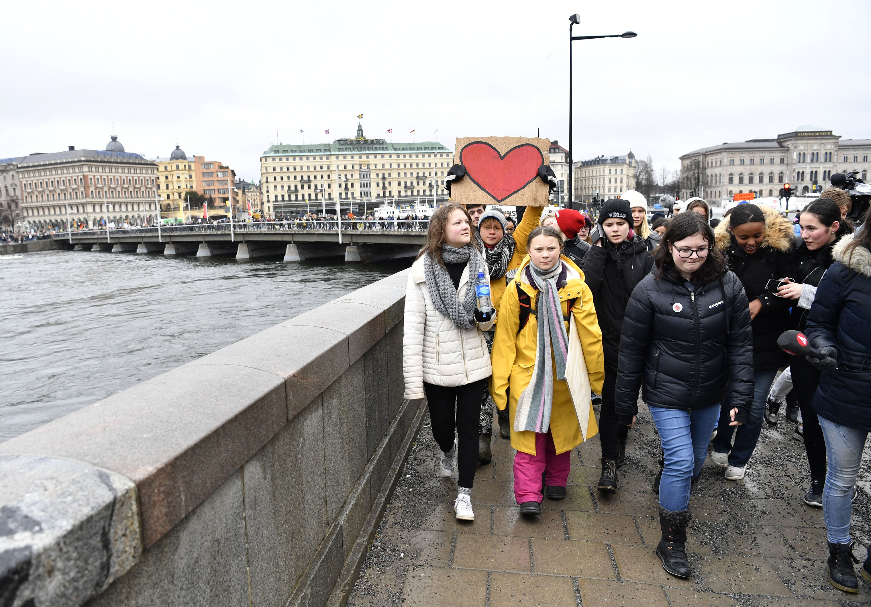 Activist Greta Thunberg, foreground centre, and her sister Beata Thunberg, left, participate in a climate protest, in central Stockholm, Sweden, on March 15, 2019. (Henrik Montgomery—AP)
