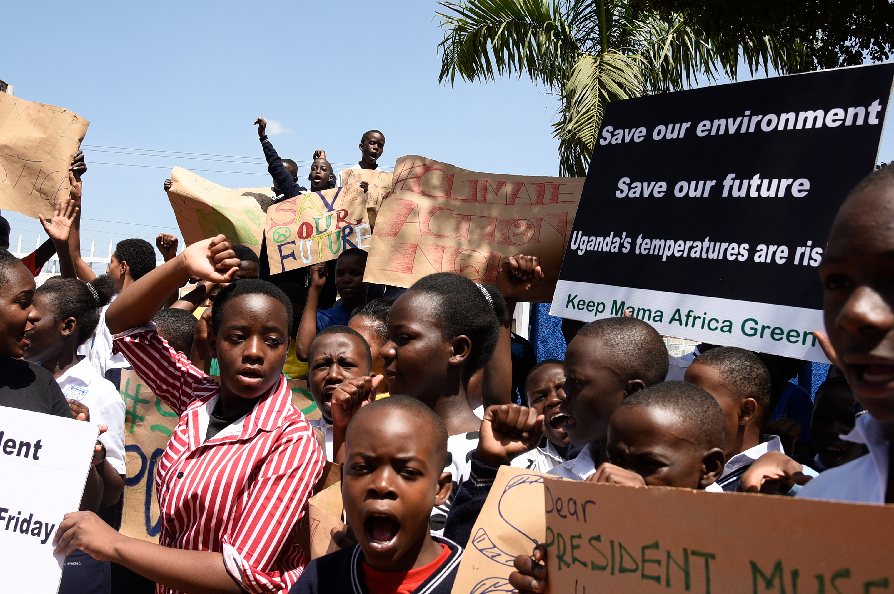 Students hold placards during a strike as part of a global day of student protests aiming to spark world leaders into action on climate change, in Kampala, Uganda on March 15, 2019. (Isaac Kasamani—AFP/Getty Images)