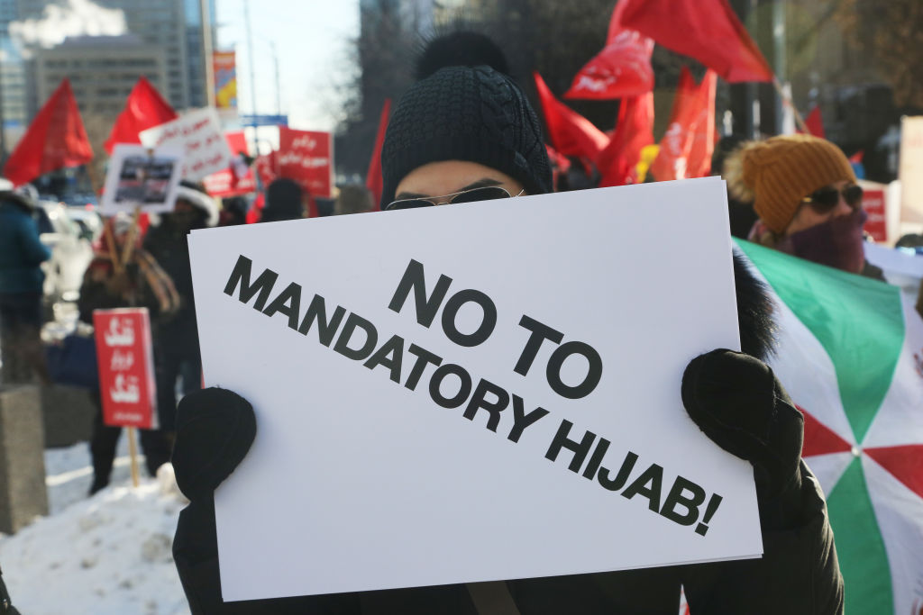 Protestor holds a sign saying 'No to Mandatory Hijab' as hundreds of Canadians take part in a protest against the Islamic Republic of Iran in Toronto, Ontario, Canada, on January 6, 2018. (Creative Touch Imaging Ltd.—NurPhoto via Getty Images)