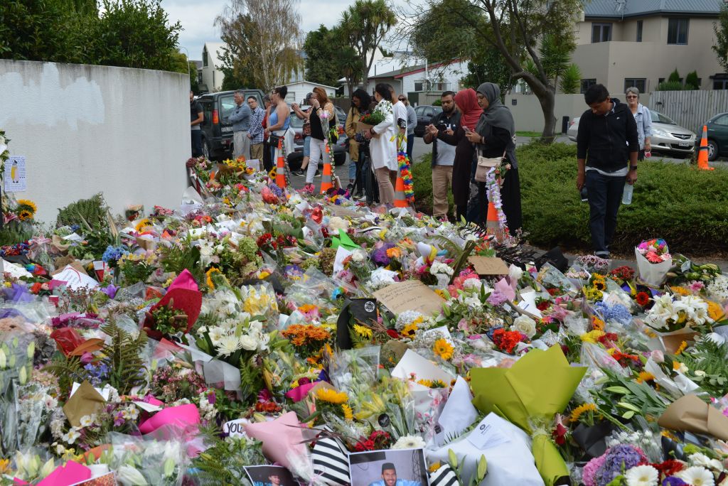 People place flowers at memorial sites as a tribute to victims of the Fridays terrorist attacks on two mosques that left at least 50 people killed in Christchurch, New Zealand on March 19, 2019. (Anadolu Agency—Getty Images)