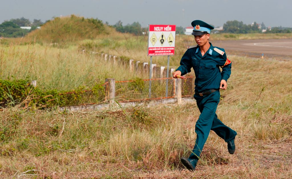 A Vietnamese soldier runs past the dioxin contaminated area of the Bien Hoa airbase on the outskirts of Ho Chi Minh City, Vietnam, on Oct.17, 2018. (Contributor—KHAM/AFP/Getty Images)