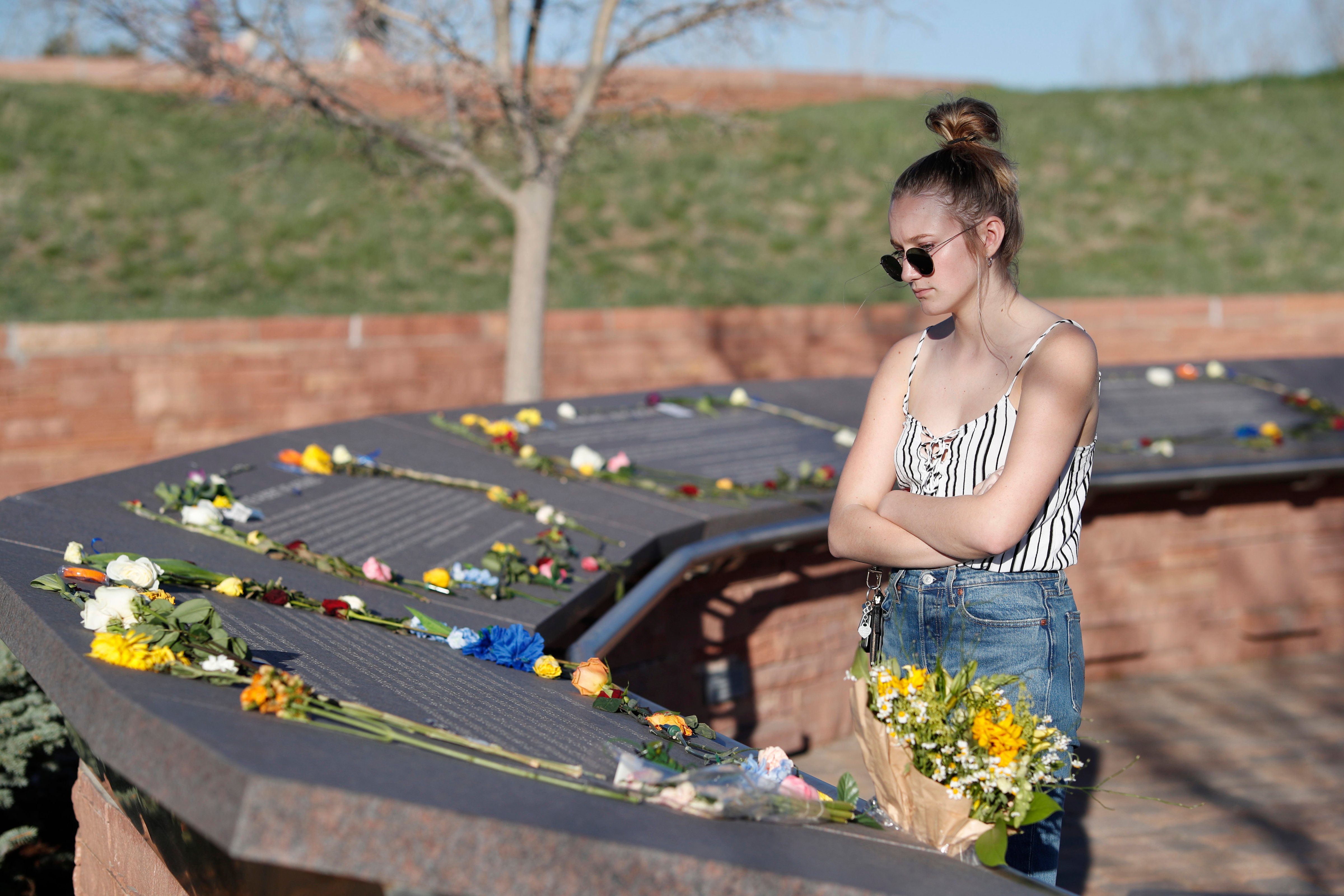 Sixteen-year-old Maren Strother of Denver looks over the plaques on April 19, 2019 for victims of the Columbine High School massacre before a vigil marking the 20th anniversary of the shooting in Littleton, Colo. (David Zalubowski—AP)