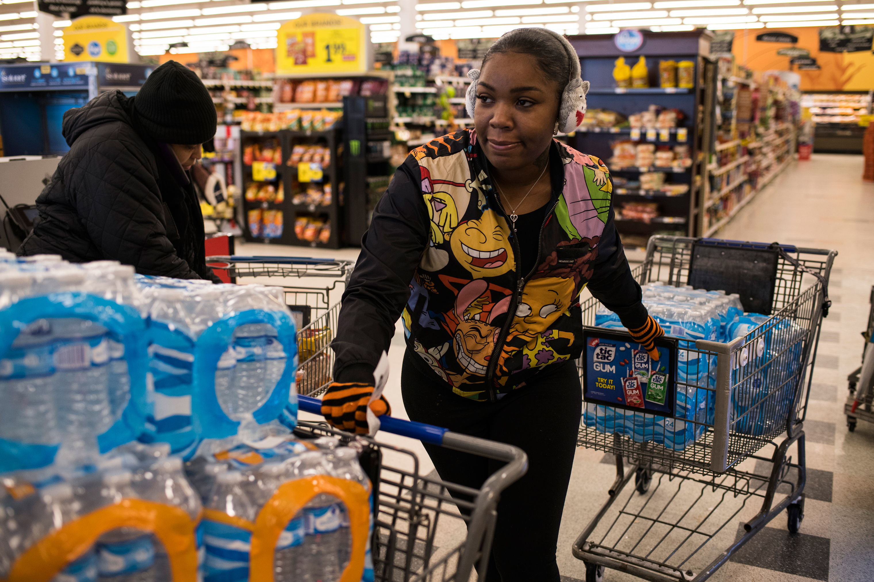 Flint residents ask Hawk for help getting safe water; she’s seen here in January buying cases to distribute. (Brittany Greeson for TIME)