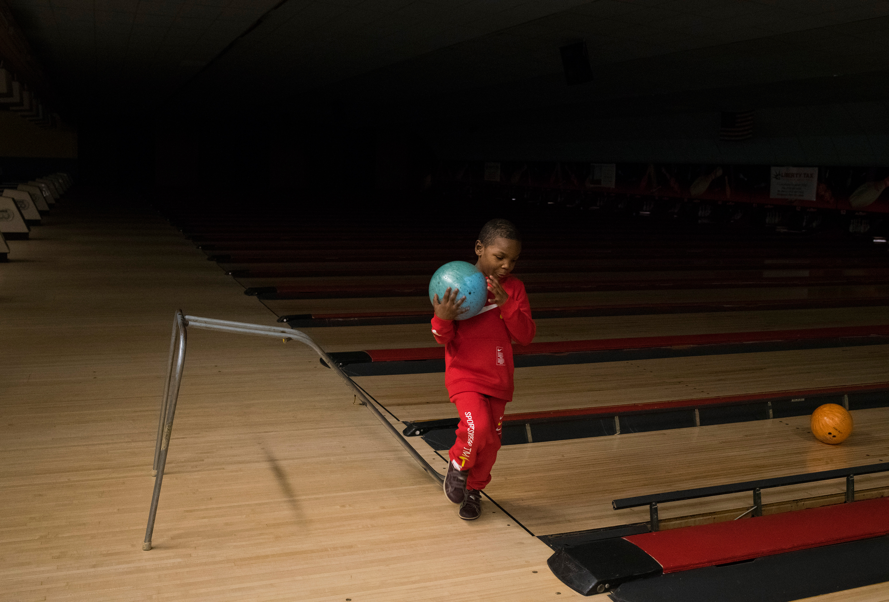 Sincere picks up his ball while bowling for his sixth birthday party in Grand Blanc, Mich., on Feb. 4. (Brittany Greeson for TIME)