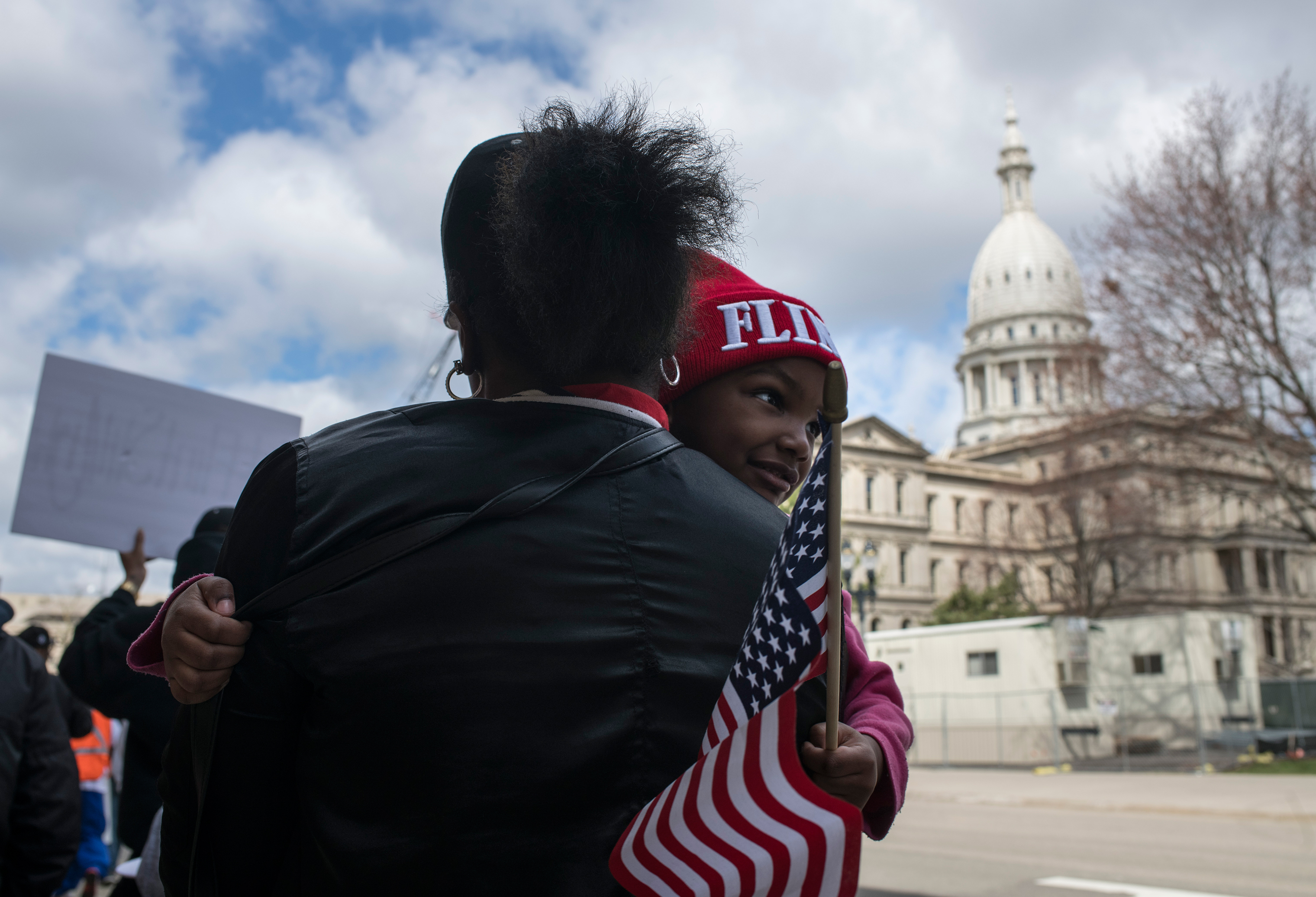 On the fourth anniversary of the water switch that caused the lead pollution, Hawk and daughter Aliana joined other Flint residents last year protesting at the Michigan state capitol. (Brittany Greeson for TIME)