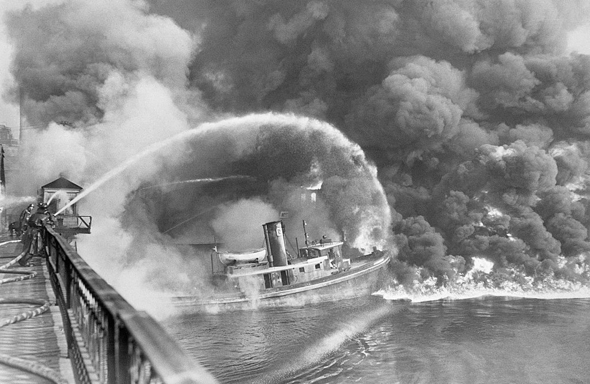 Firemen trying to put out a 1952 blaze on the Cuyahoga River. (Bettmann—Getty Images)