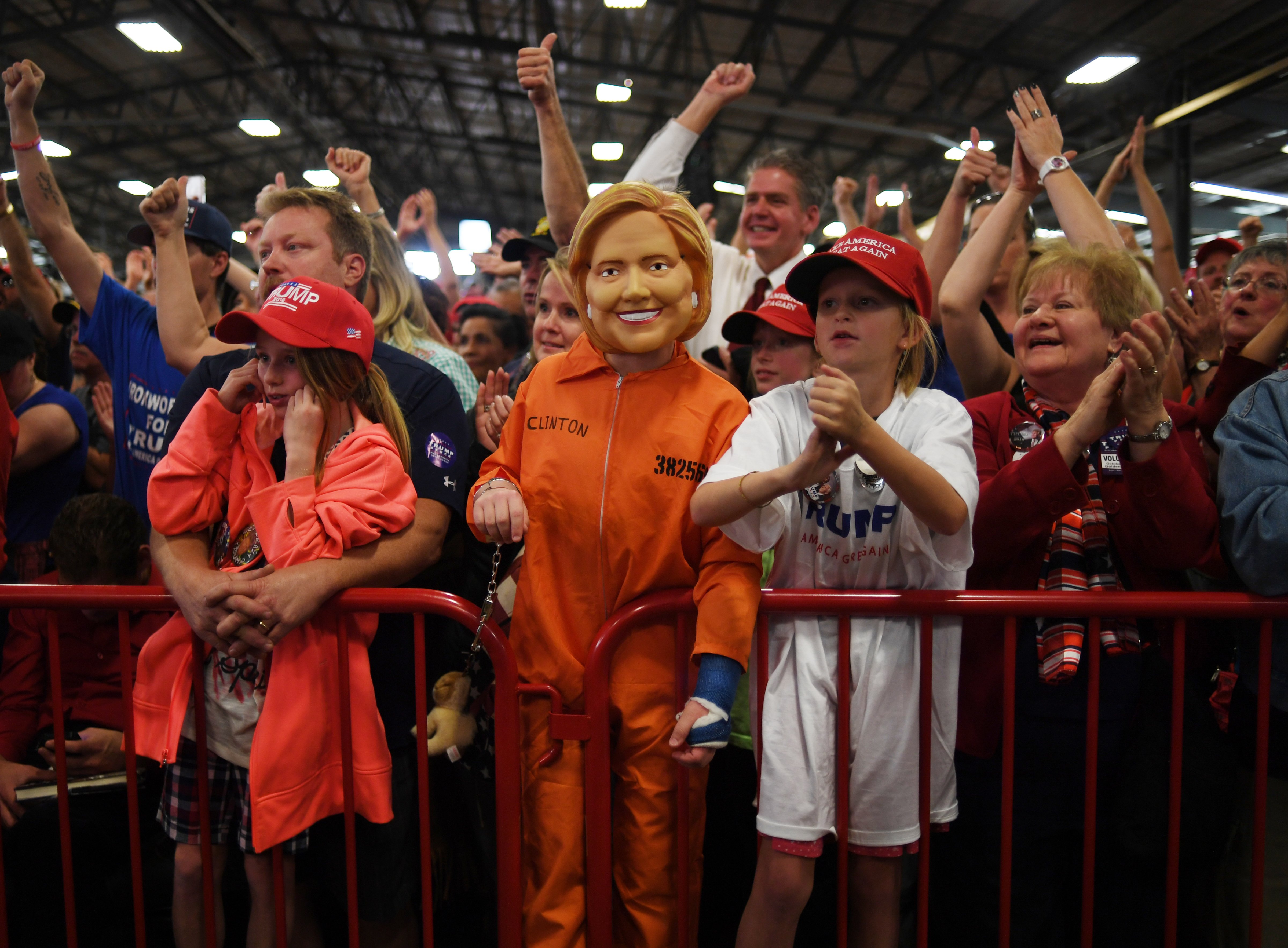 Daniel Lance, 11, dresses as Hillary Clinton in a prison orange jumpsuit during a campaign rally, for Donald J. Trump, at the Jefferson County Fairgrounds in Golden, Oct. 29, 2016. (RJ Sangosti—Denver Post via Getty Images)